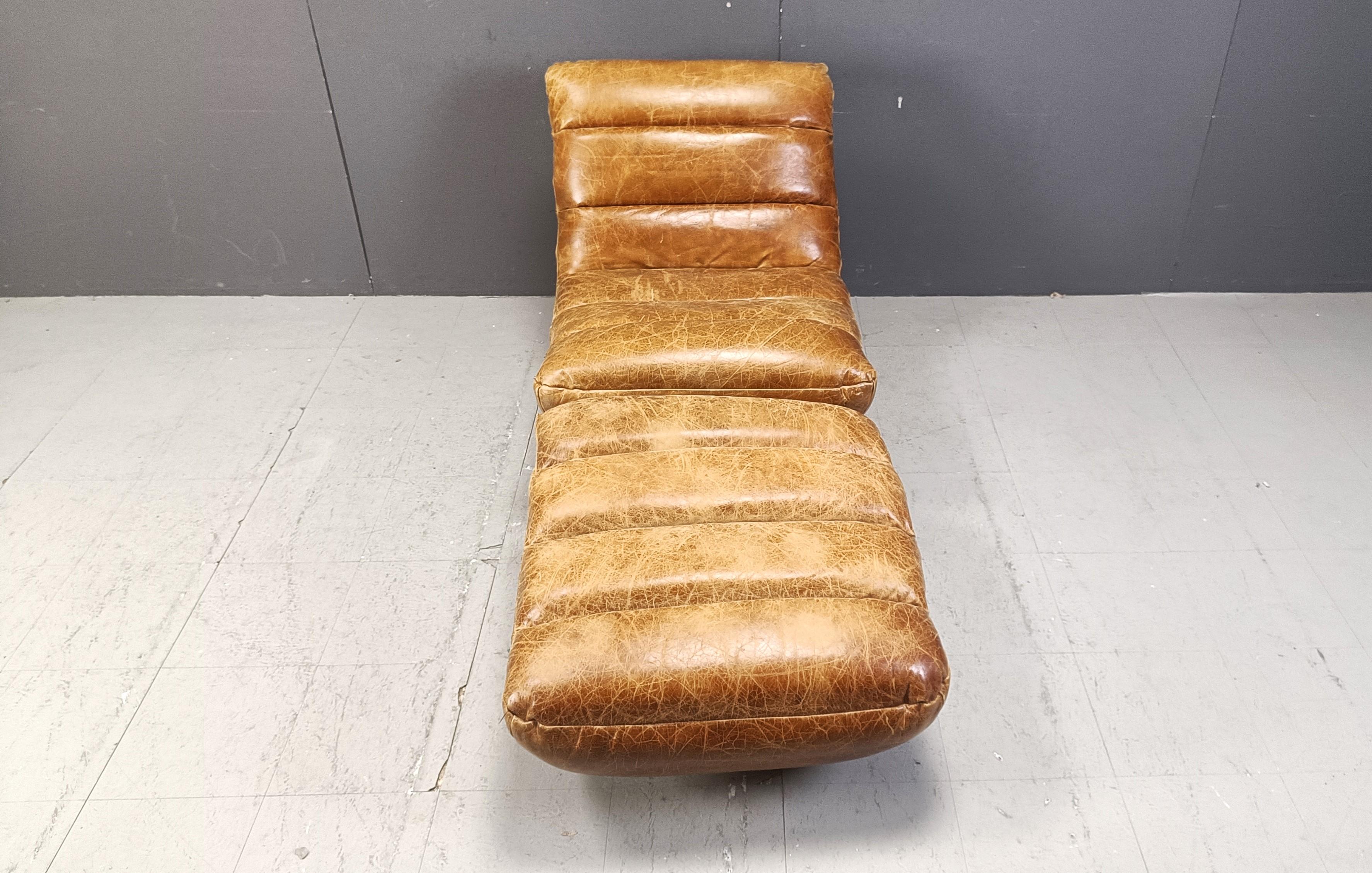 Mid century modern brown leather swivel chair with foot stool

Very comfortable swivel chair with thick patinated leather cushions.

Beautiful condition

Chromed bases.

1970s - Belgium

Dimensions:
Height: 85cm
Width: 75cm
Depth: 90cm
Seat height: