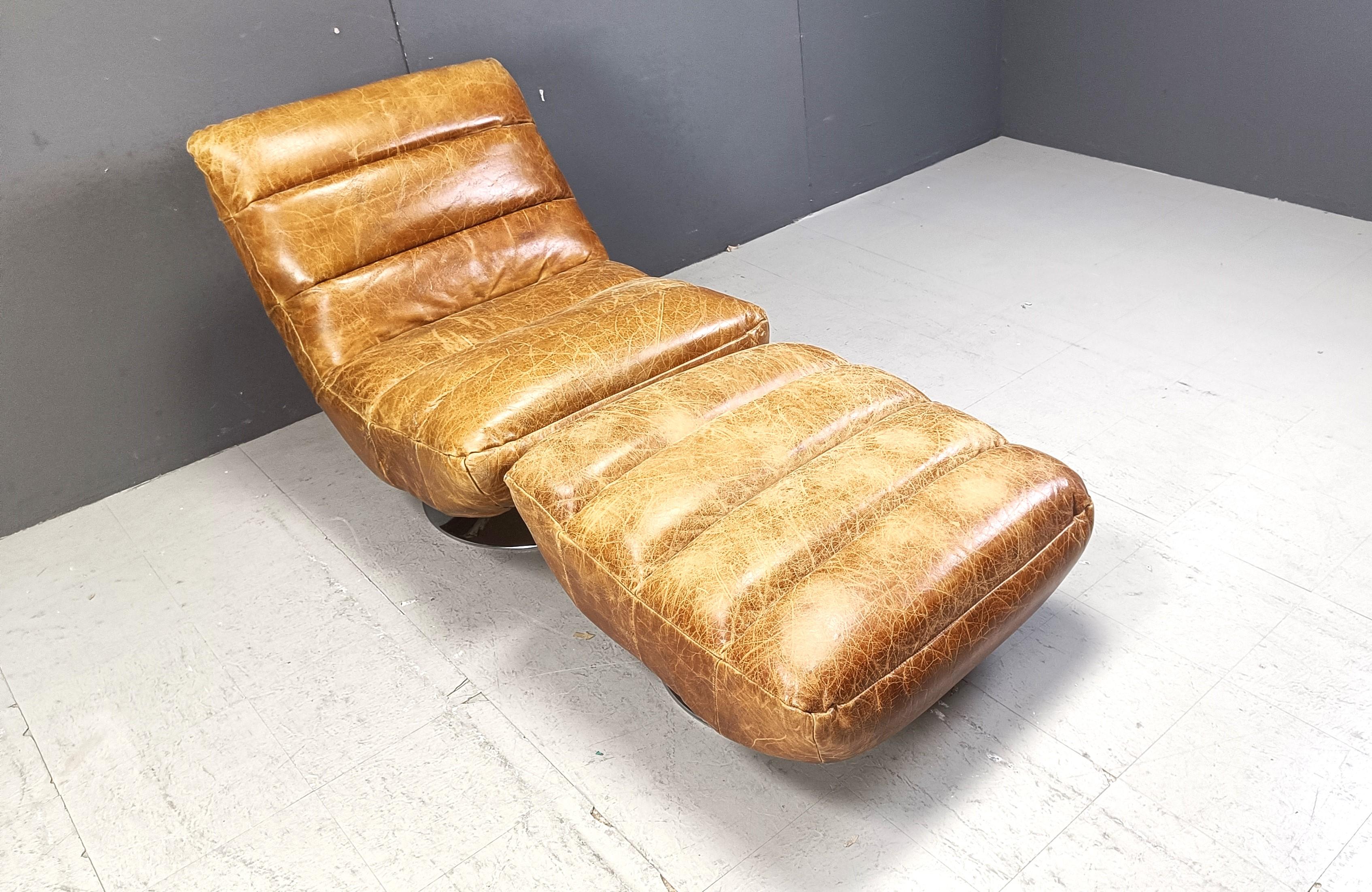 Belgian Vintage leather swivel chair with stool, 1970s For Sale