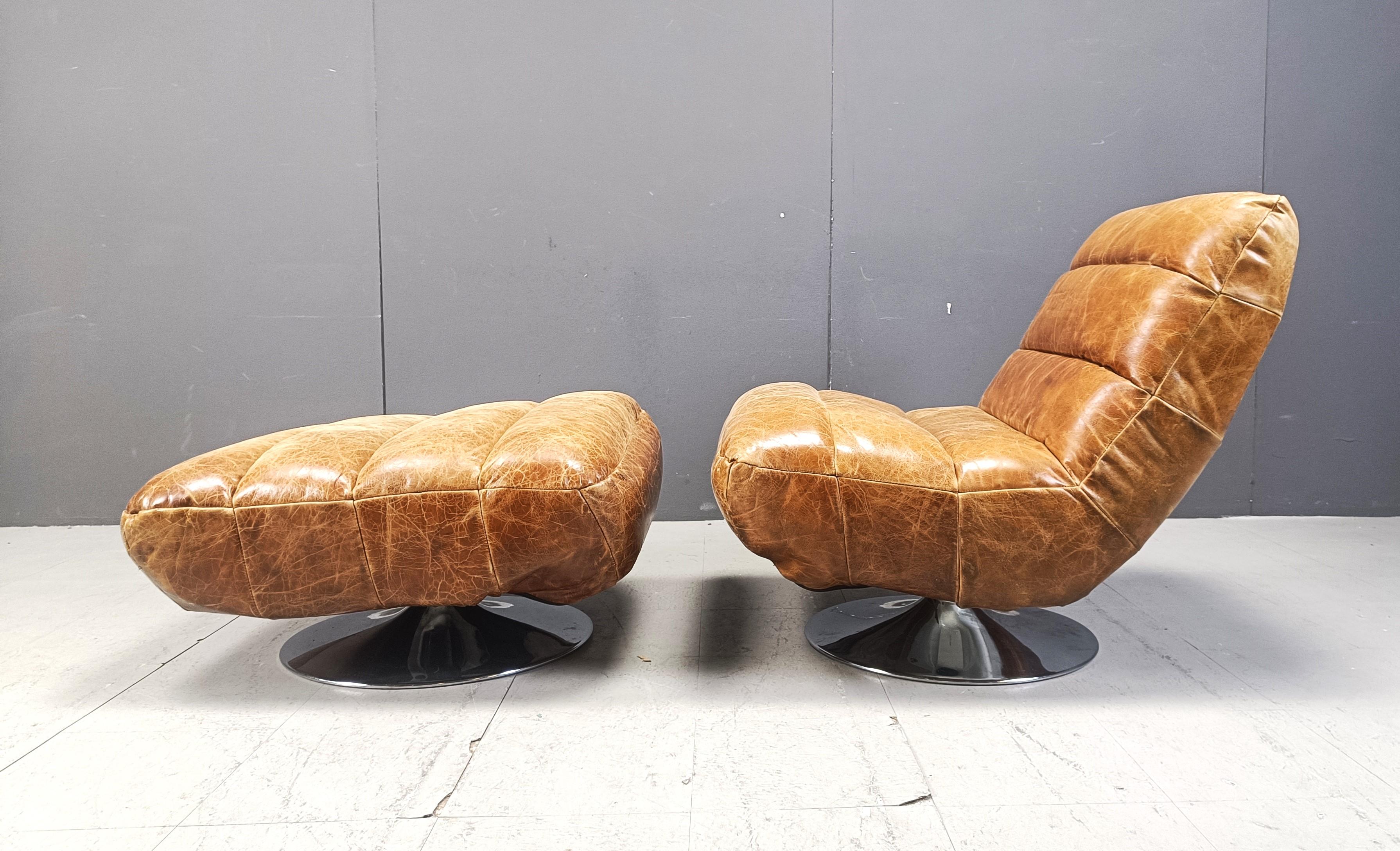 Leather Vintage leather swivel chair with stool, 1970s For Sale