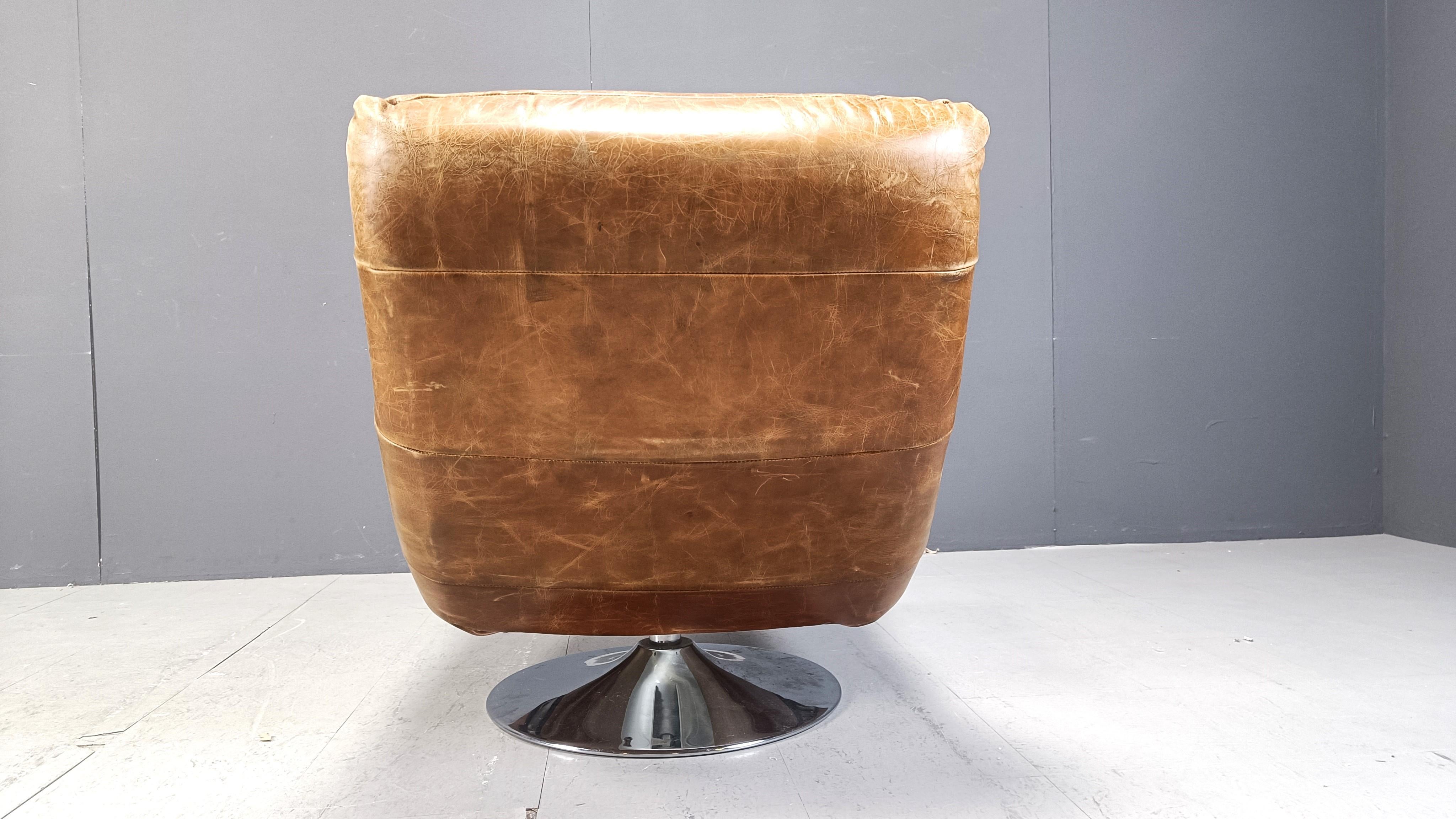 Vintage leather swivel chair with stool, 1970s For Sale 2