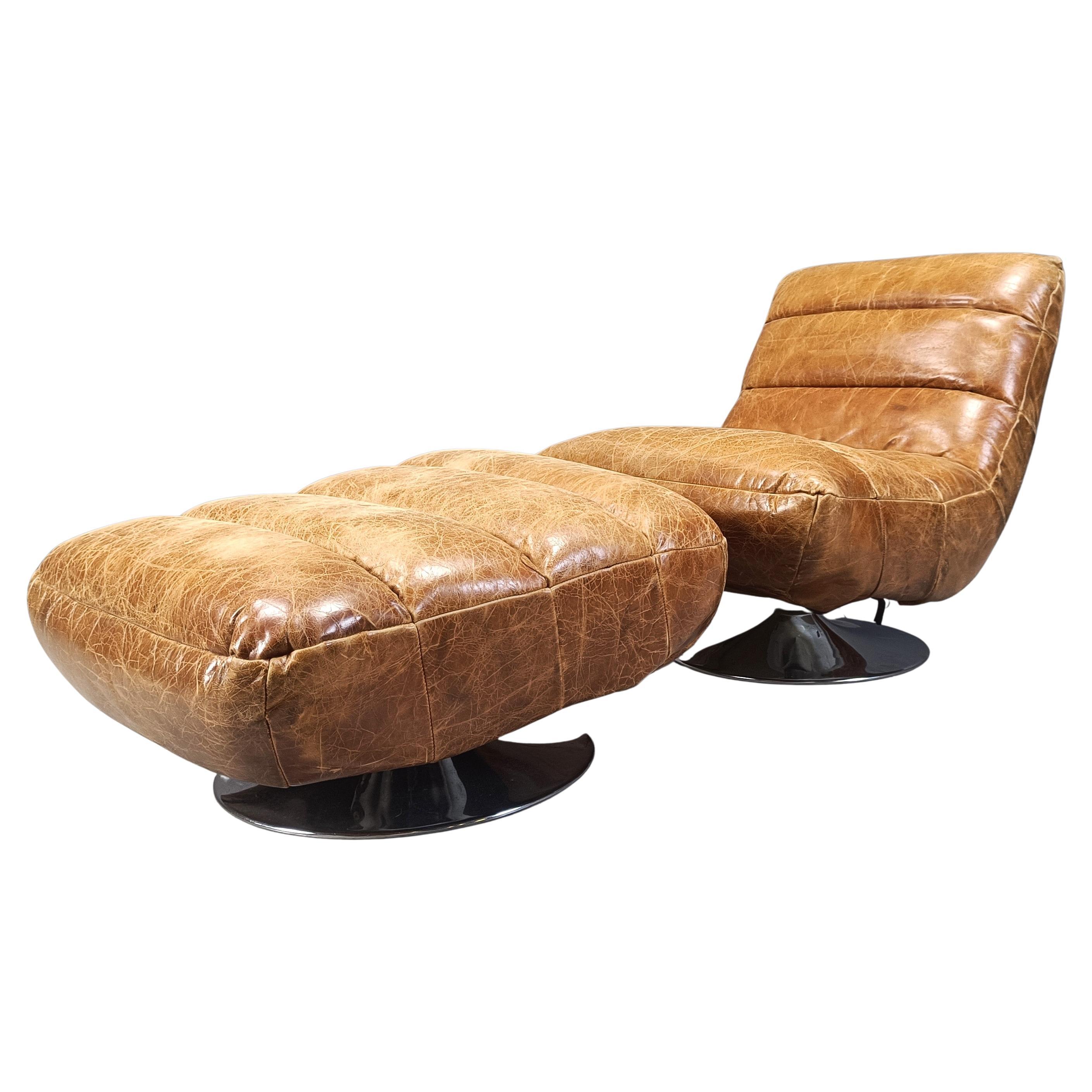 Vintage leather swivel chair with stool, 1970s