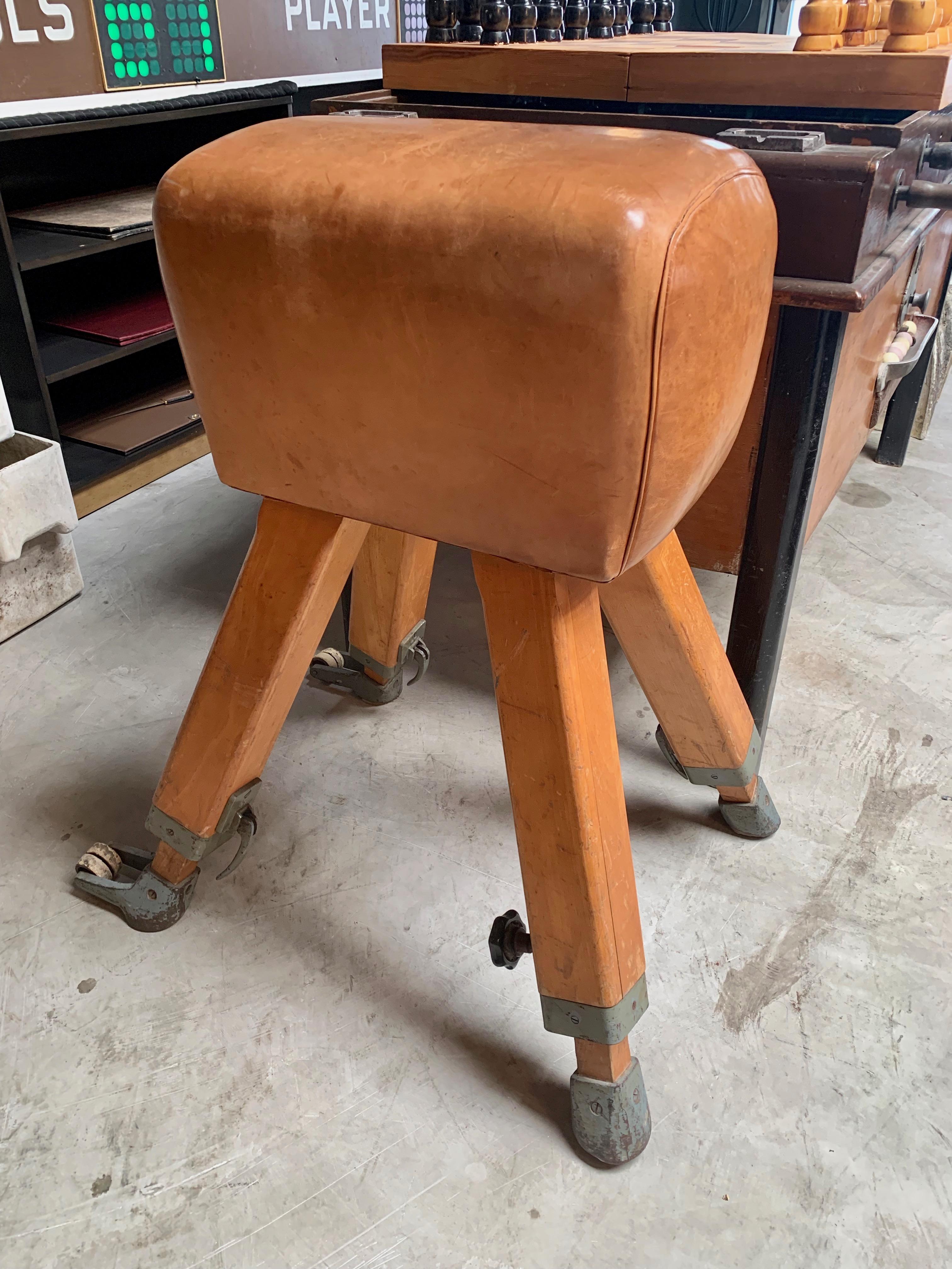 Great vintage leather and beechwood vaulting horse. Adjustable height. Excellent patina and color to leather. Great vintage condition. Great for a gym or eclectic seat.