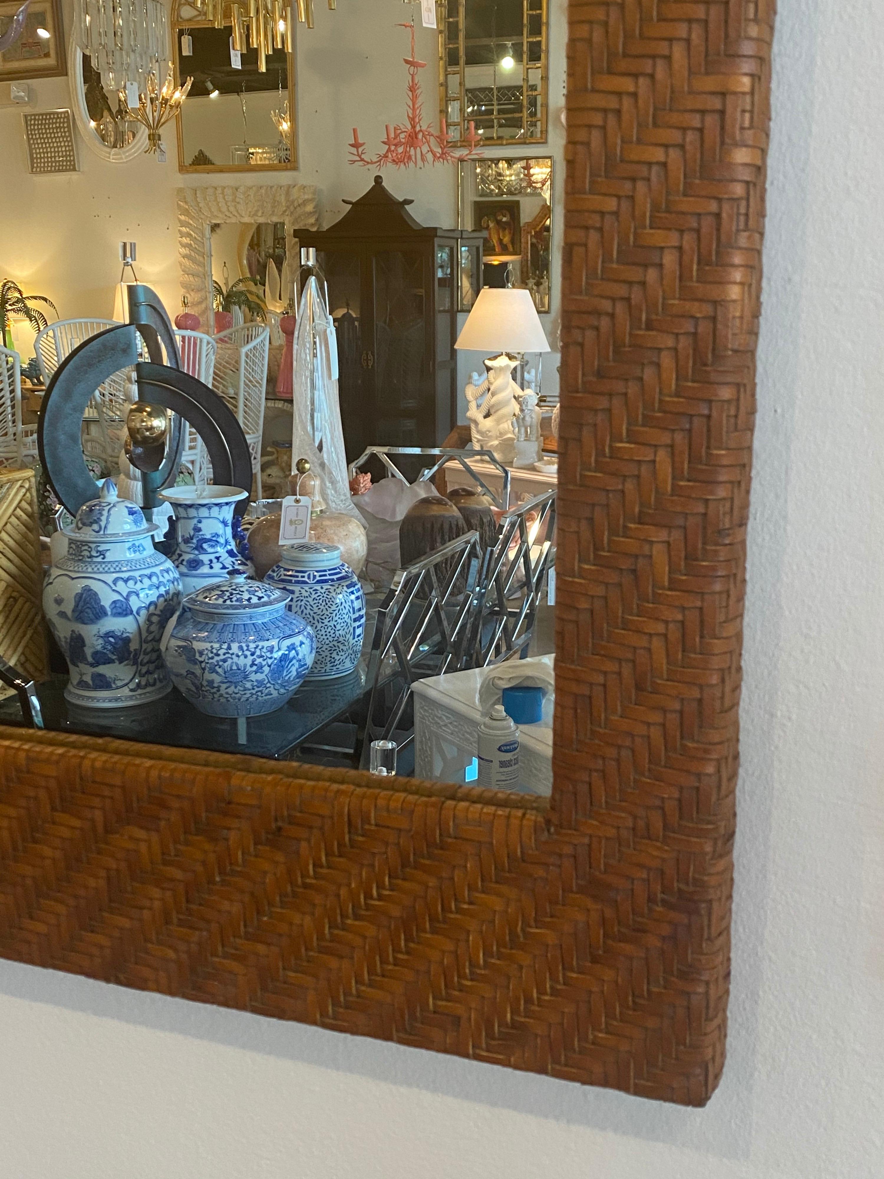 Lovely vintage wall mirror. Leather weaved that looks like wicker. No damage or defects.
  