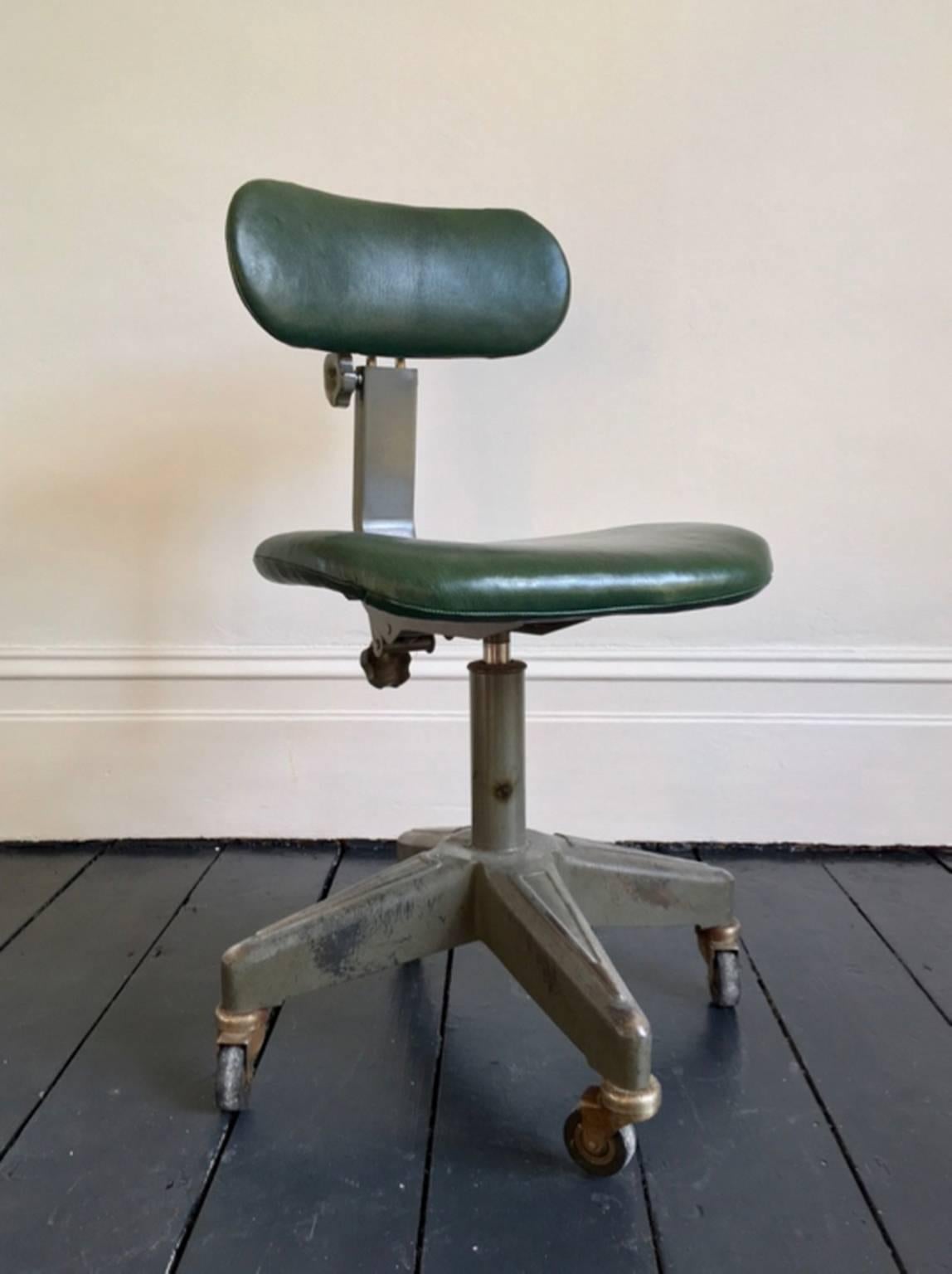 Heavy Industrial work chair. European, probably 1930s or 1940s.

This is a good sturdy piece on casters with adjusting and swivel mechanisms to affect seat height and backrest positions. The metal frame is finished in dark grey or green paint