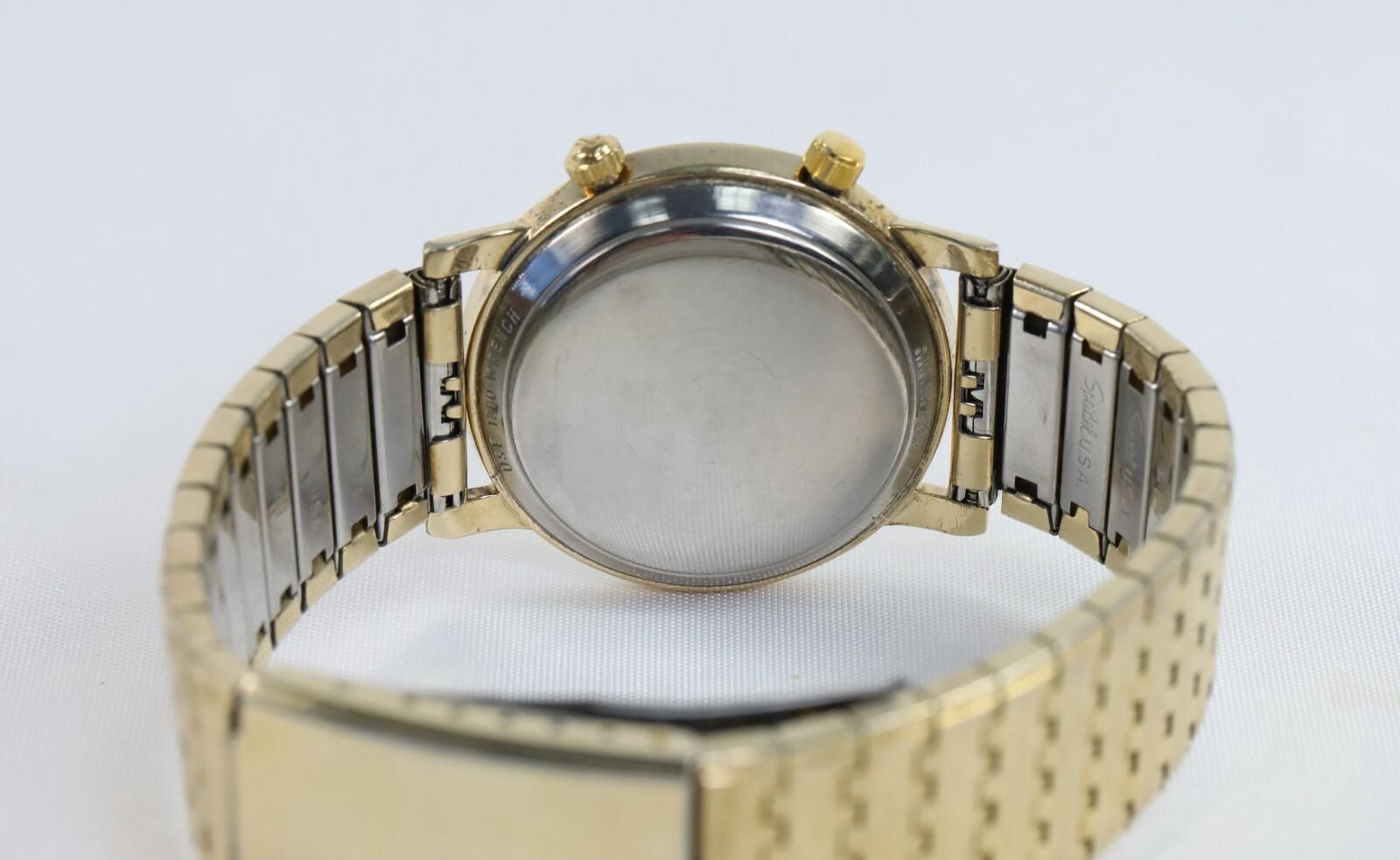 This vintage LeCoultre Memovox automatic watch is a timeless example of mid-century horological design. Featuring a 34mm case with a 10k yellow gold shell, it showcases a classic silver-tone Roman numeral dial paired with dual crowns—one for time