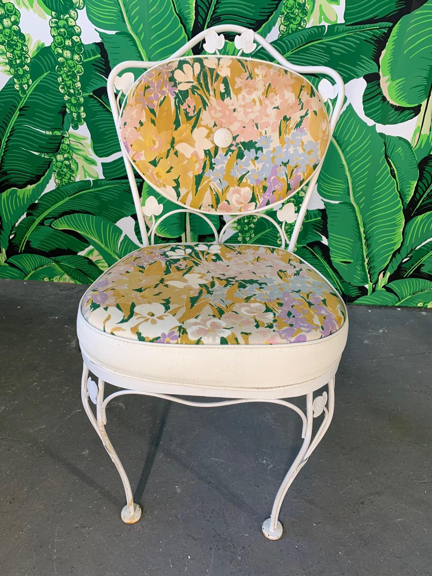 Vintage wrought iron patio chairs by Lee Woodard and Sons (father of Russell Woodard) features original floral upholstery and decorative ivy detailing. Good vintage condition with imperfections consistent with age.