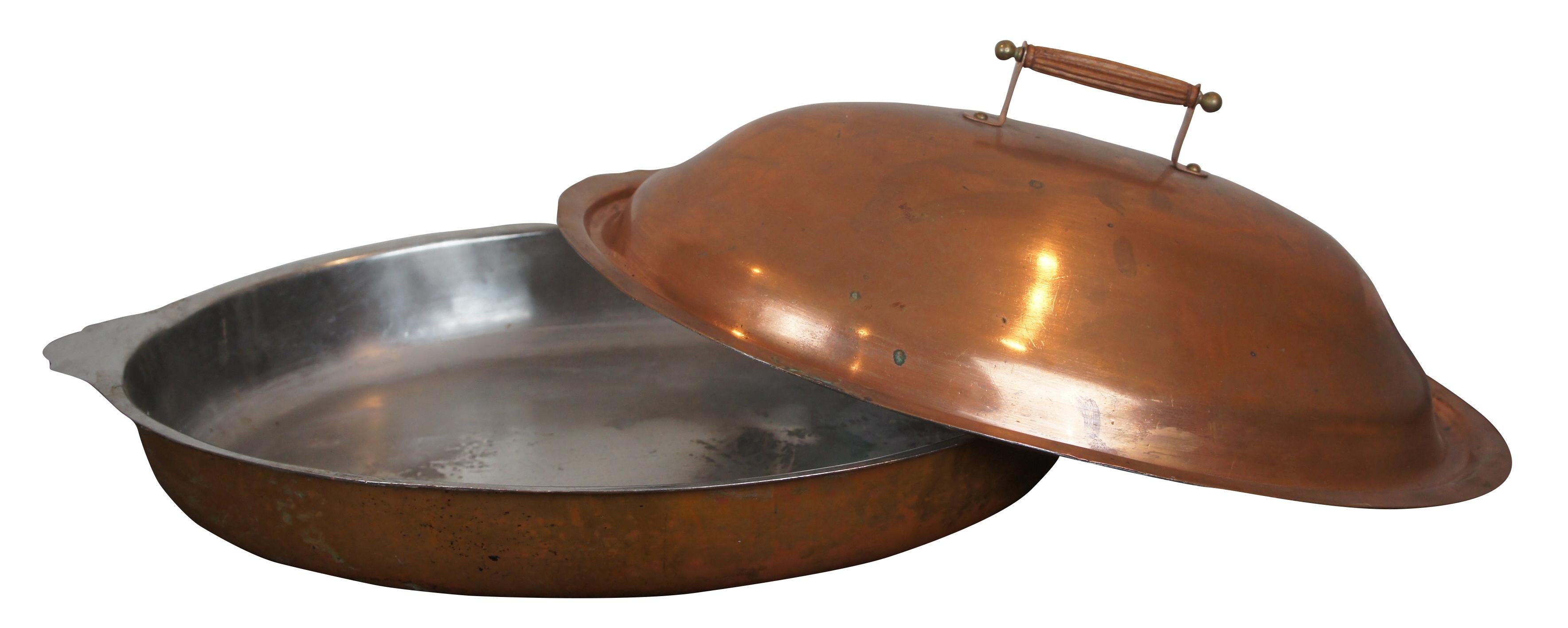 Vintage large Legion Utensils Scavullo copper platter with cover / chafing / casserole / roasting dish featuring oval form with tin lining and wood handle. 9, 55.
      