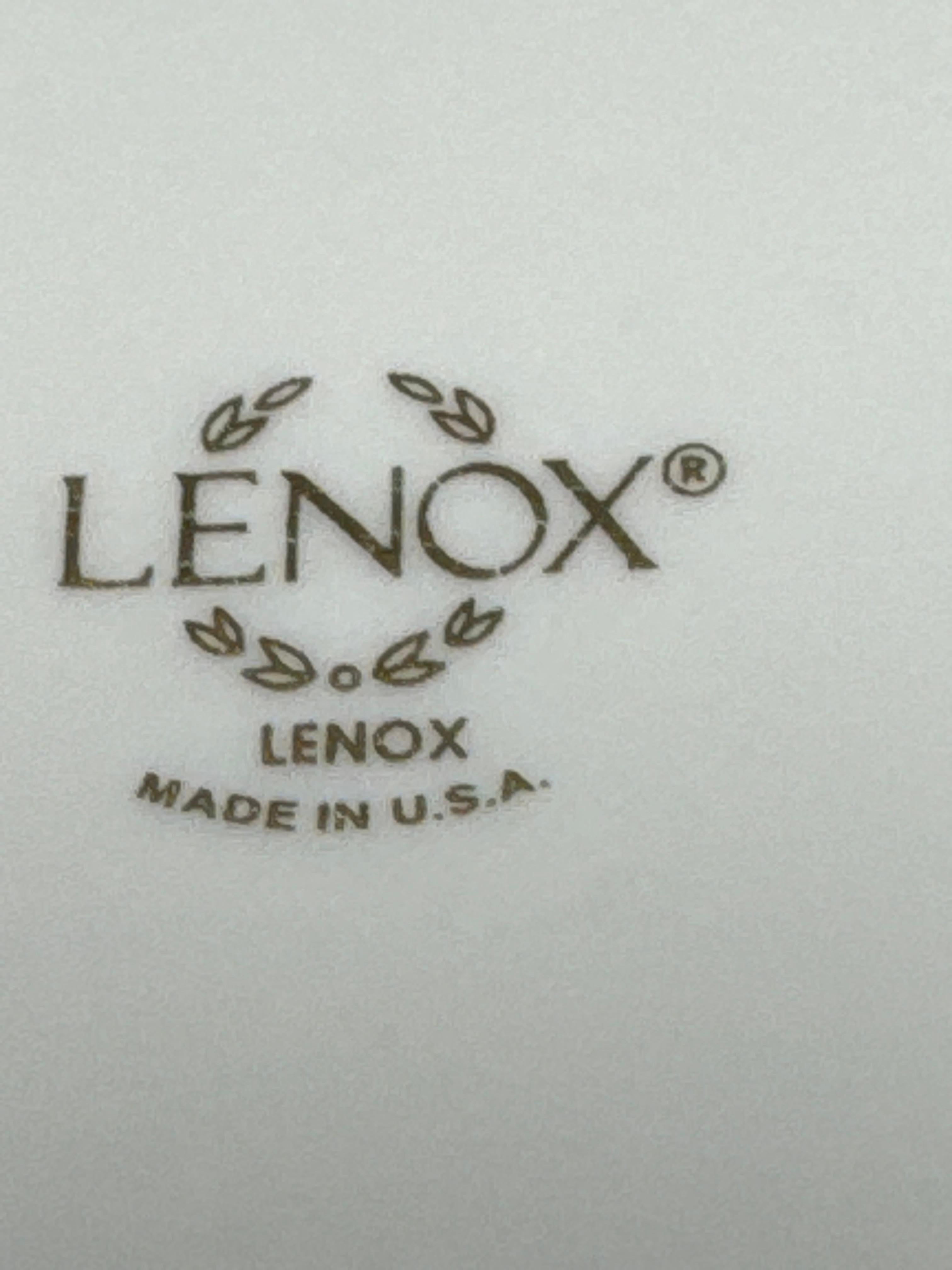 Die legendäre Eleganz von Lenox präsentiert Holiday, ein Band aus festlicher grüner Stechpalme und roten Beeren vor einem luxuriösen cremefarbenen Hintergrund, der von einem atemberaubenden breiten polierten 24-karätigen Goldrand umrahmt wird.