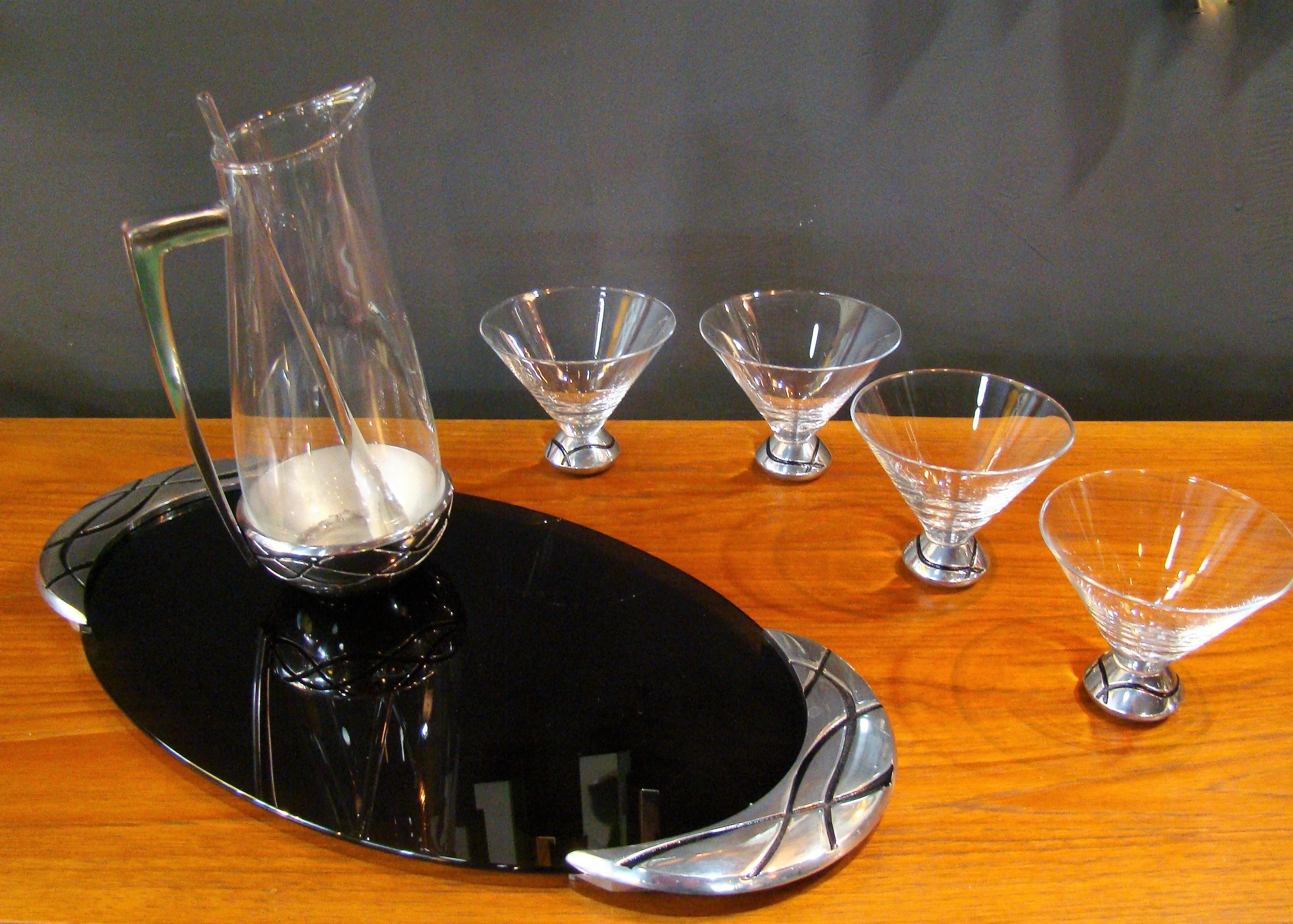 Lenox Spyro 7 Piece Martini Set: Metal accents and an irreverent design bring modern flair to your entertaining. Set includes four martini glasses, pitcher, glass stirrer and tray. Metal serveware by Lenox is made from durable tarnish free alloy,
