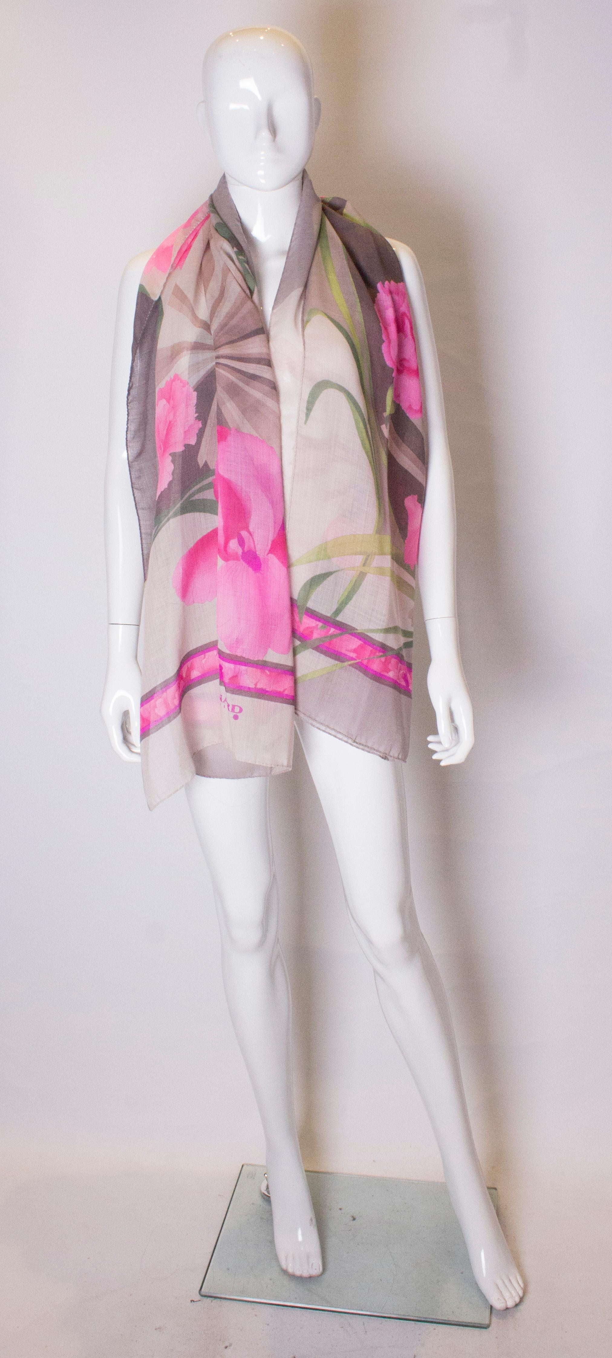 A stunning wool shawl by Leonard ,Paris. The shawl is hand rolled and has a beige bakcground with a pink floral print.