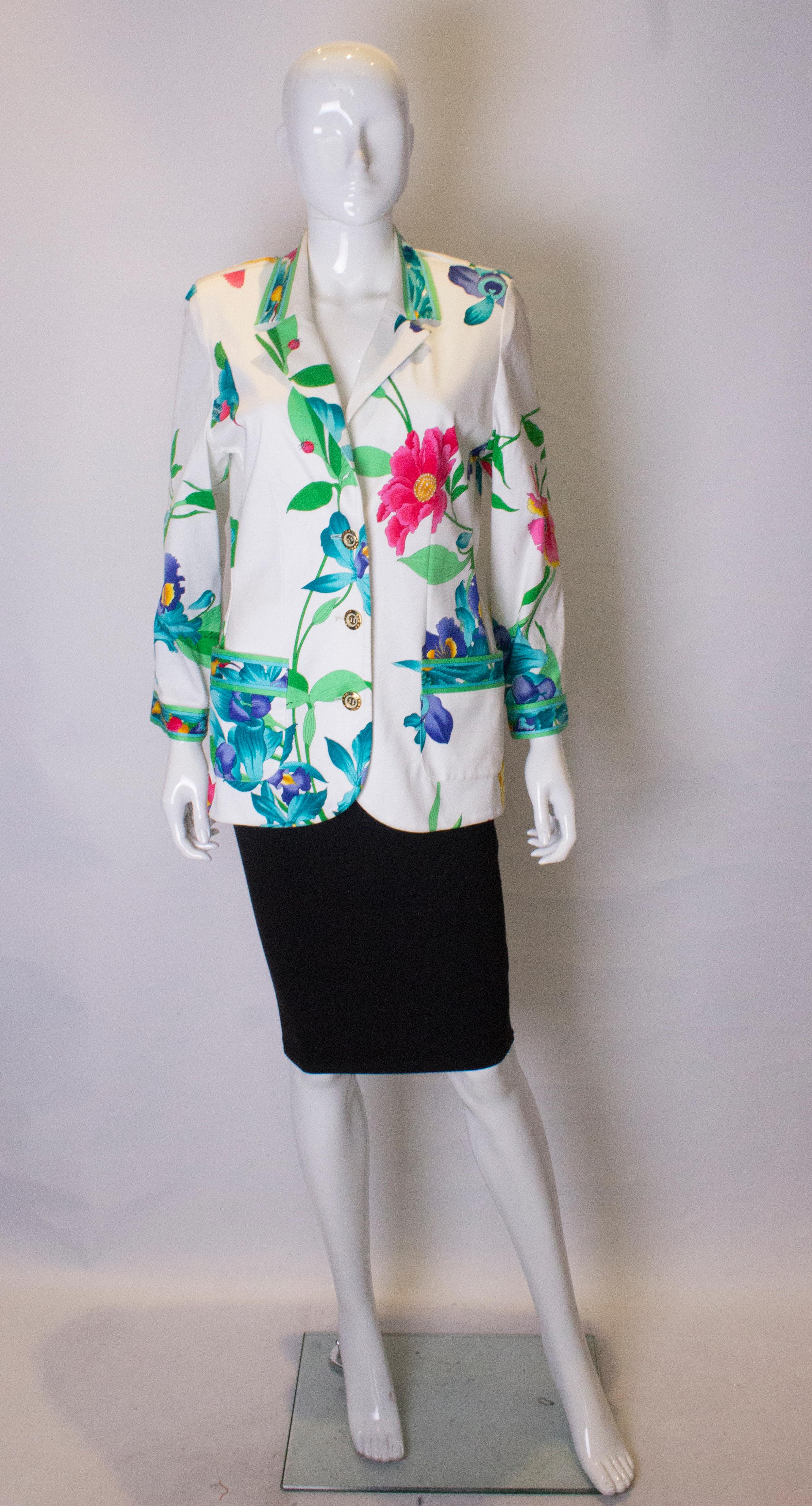 A great vintage jacket by Leonard. With a white background, the jacket has a multicolour floral design, and two pockets at hip leval.