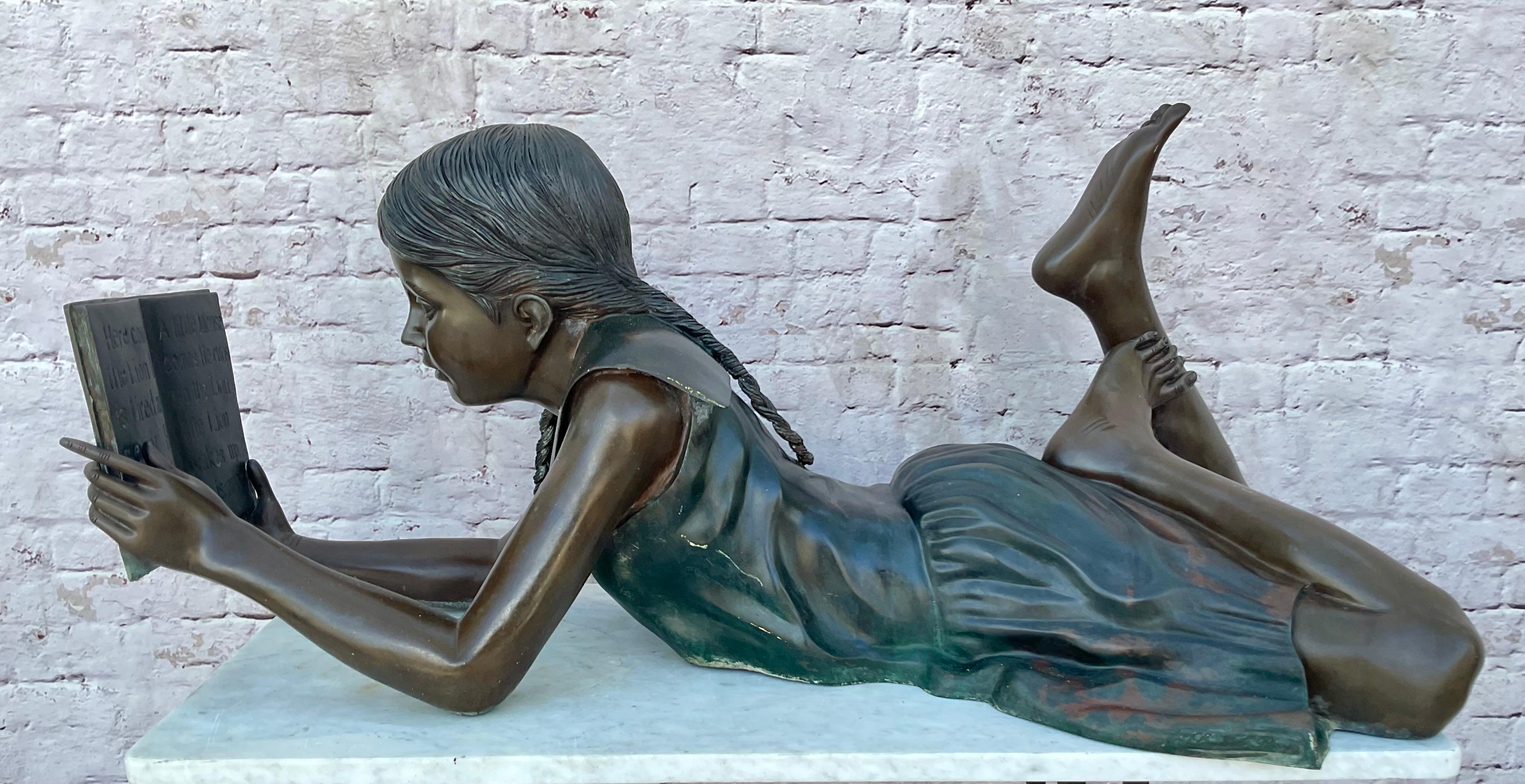 Leonardo Rossi in detailed Life-Sized Bronze Sculpture depicting a young girl reading a book of fairy tales. Artist's signature to the base in mold. Heavy bronze. Girl is lying down with legs bent at knees and feet up, while reading a book of fairy