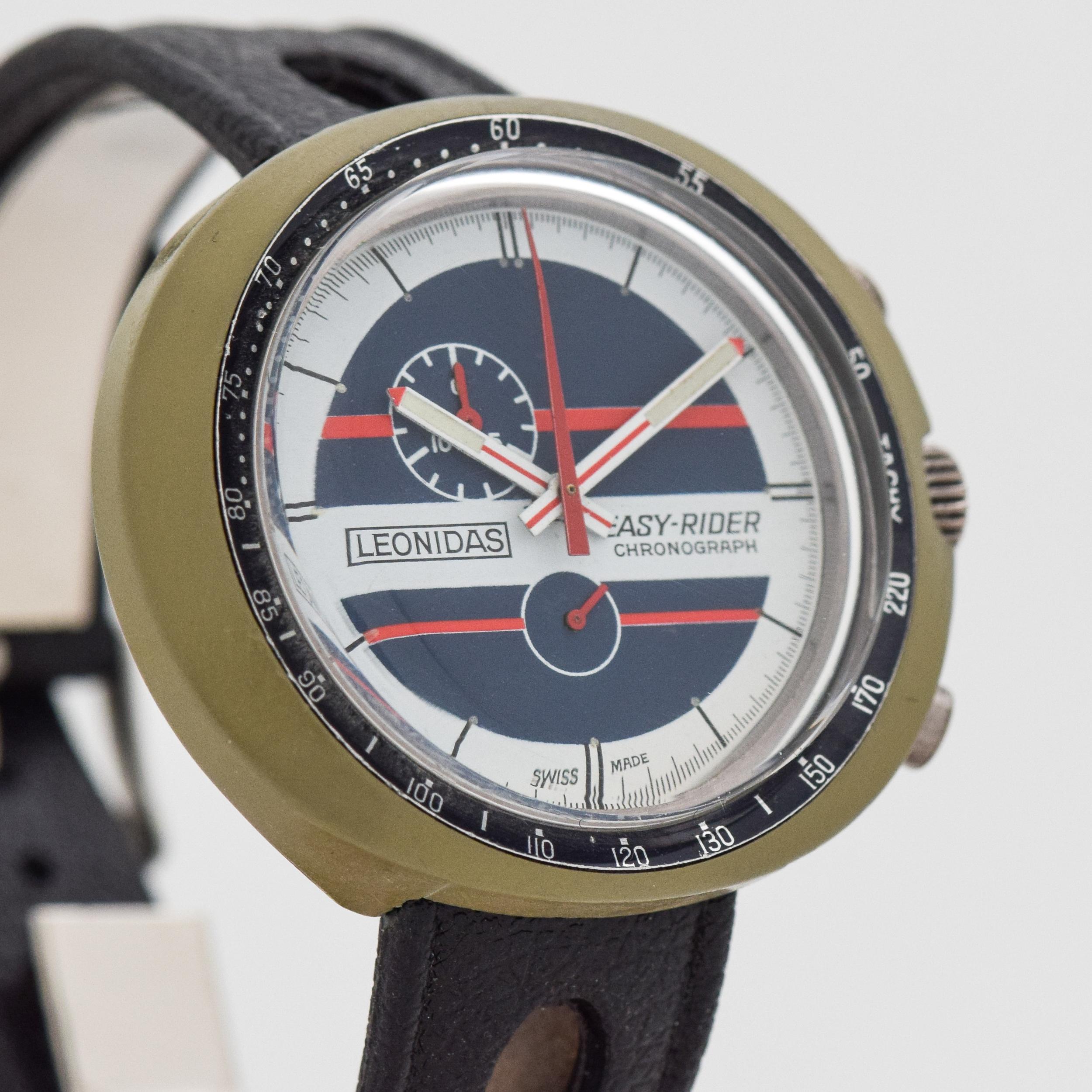 1970's Vintage Leonidas Easy Rider 1 Register Chronograph RARE Plastic Case watch with Original White, Blue, and Red Dial with Original Rubber Strap and Buckle. 45mm x 39mm lug to lug (1.77 in. x 1.54 in.) - 17 jewel, manual caliber movement. Triple