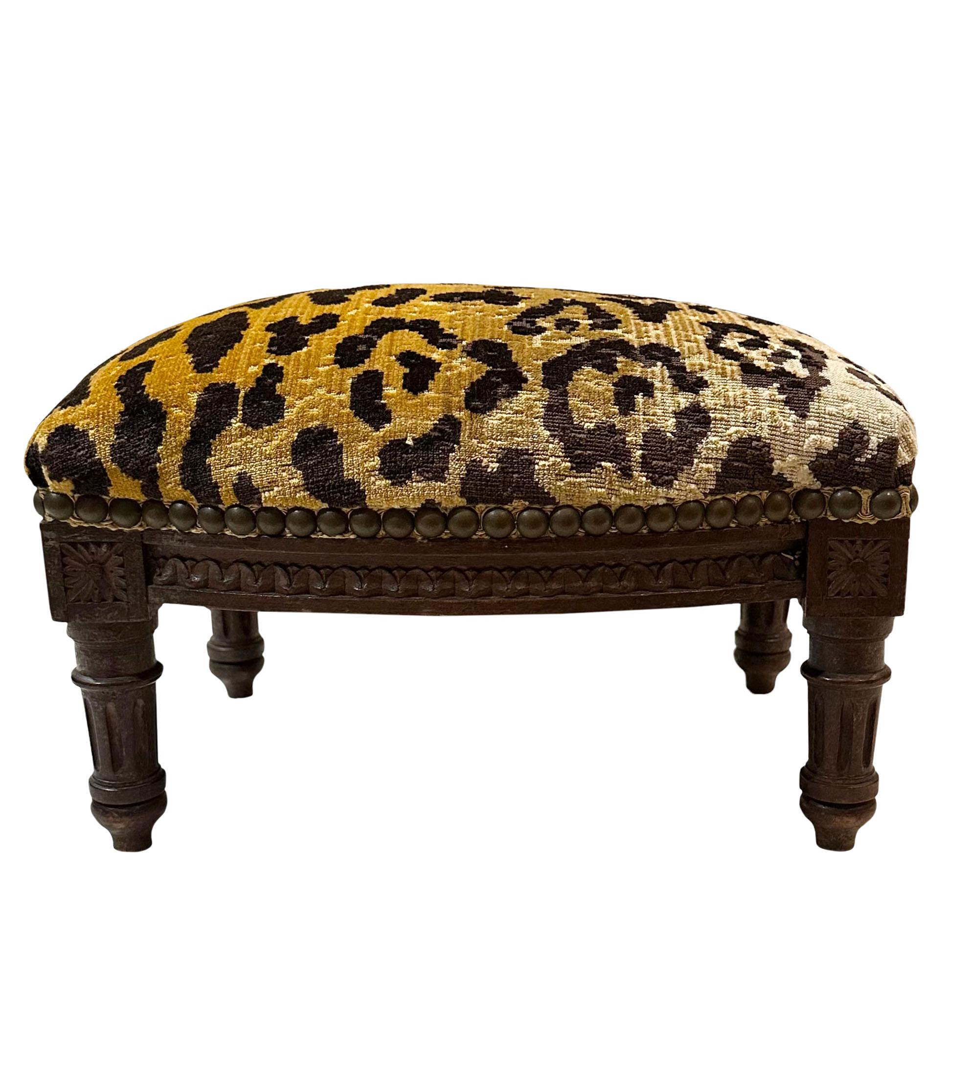 Early 19th century French stool beautifully carved. Upholstered with leopard velvet vintage fabric.

