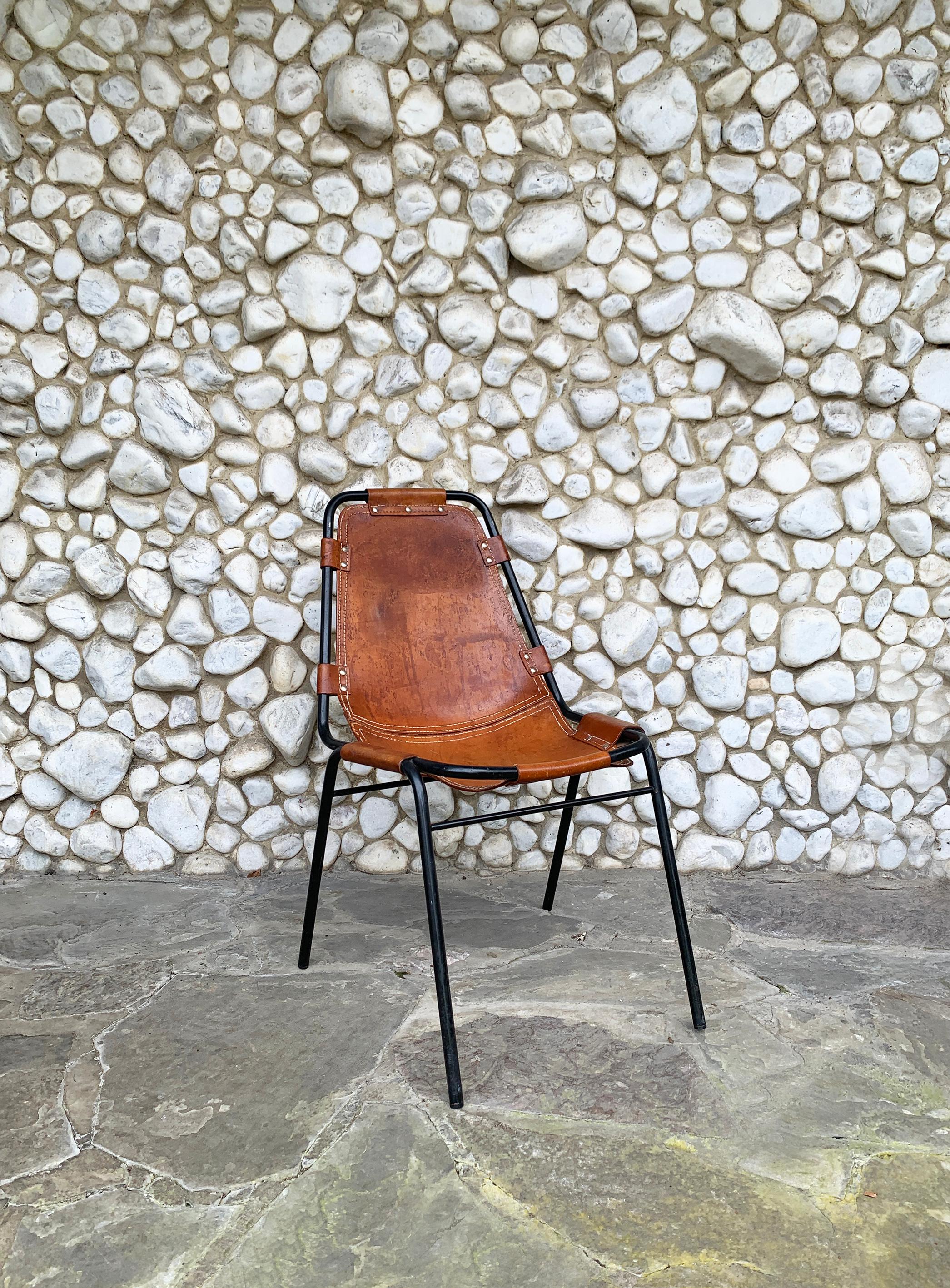 Dining chair commissioned / selected by Charlotte Perriand for the interior design of the appartements of 'Les Arcs' Ski Resorts in the French Alps.

Chromed tubular frame in metal painted black with thick brown leather seat.

The saddle leather has