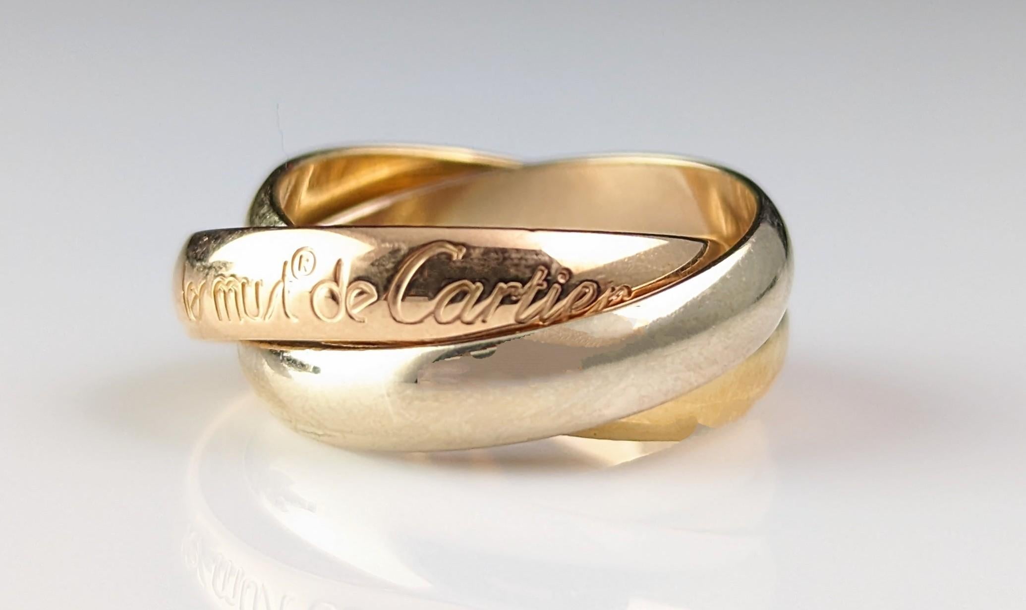 A beautiful vintage Les Must de Cartier Trinity ring.

From the timeless classic range produced by Cartier in 80s and 90s, it is a design based on the classic triple wedding band and consists of three interlocking bands.

The band's are three