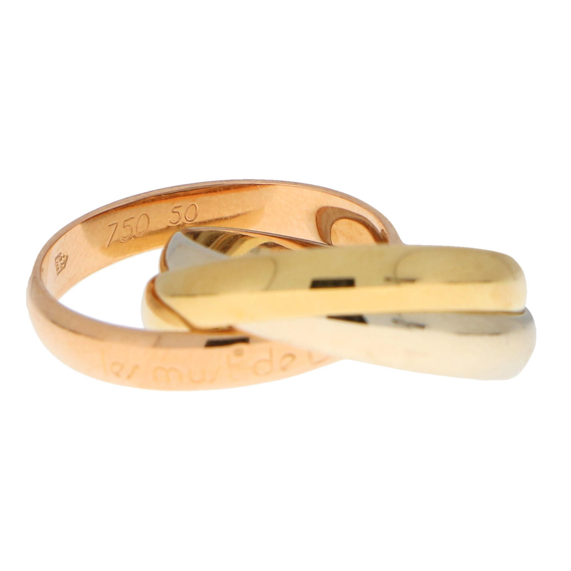 A classic Les Must De Cartier trinity ring set in 18k yellow, rose and white gold.

The ring is composed of three interlinked 3.5-millimetre bands that are designed to roll with ease on the finger. The colour difference is subtle yet beautiful and