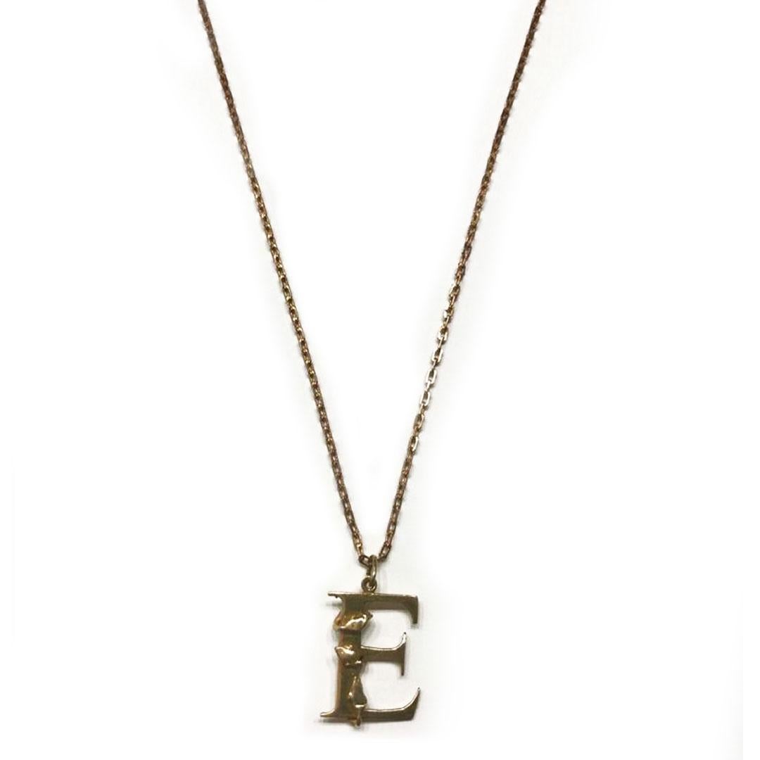 A pretty vintage letter E pendant or large charm with surmounted Ivy detail. The pendant crafted in solid 9ct yellow gold is a serifed styled letter E and delicately entwined with Ivy leaves and vines. A jump or loop ring fitting means it can be