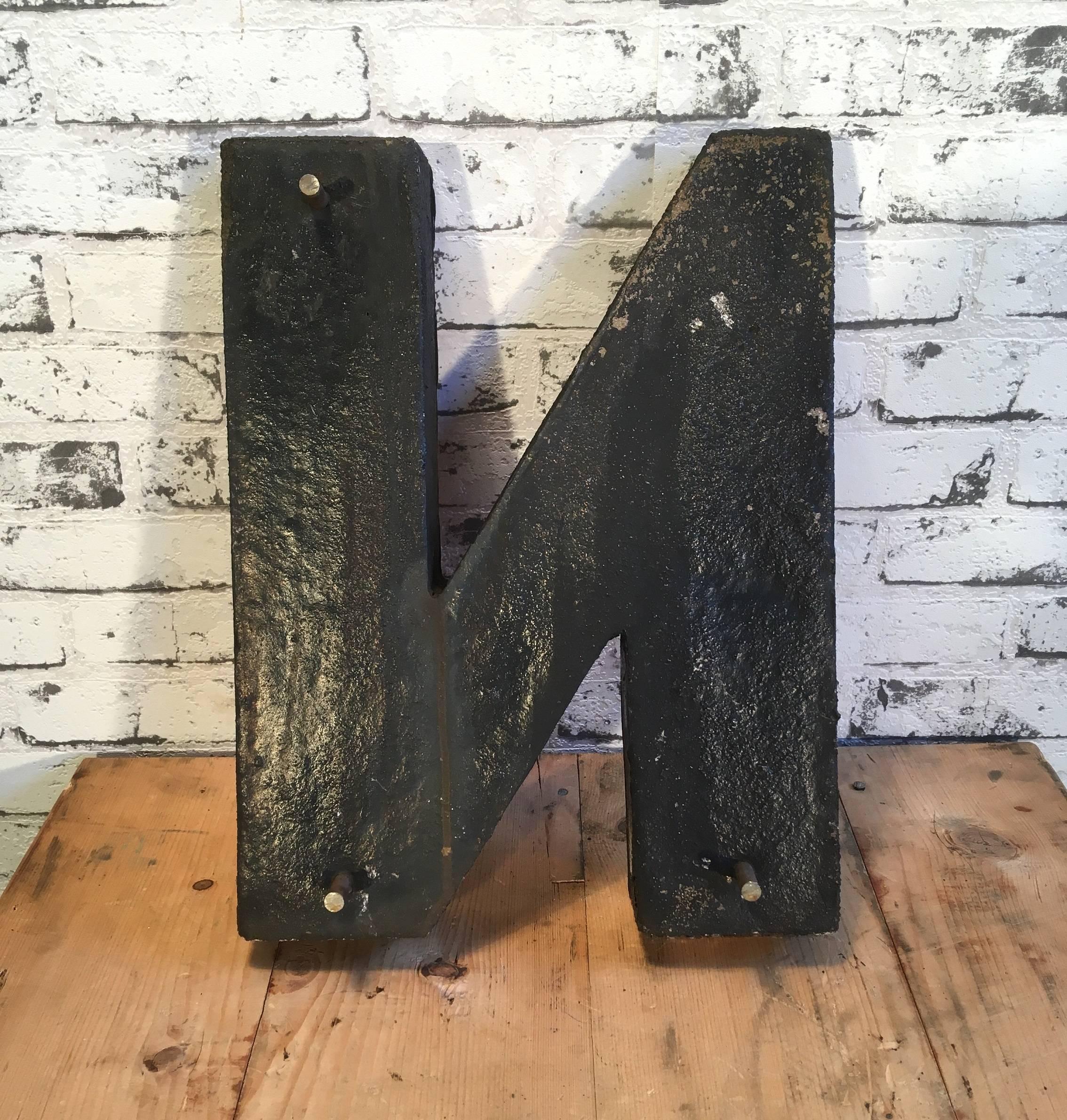 This vintage letter N comes from the old advertising banner. It is made from dyed concrete. 
Weight: 6 kg.