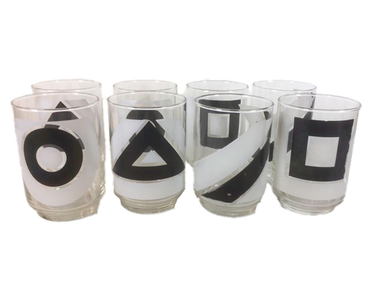 Set of eight vintage tumblers by Libbey. Decorated with geometric shaped in black and white, the set contains two each of four images: square, circle, triangle and line. The cylindrical glasses with a stepped foot.