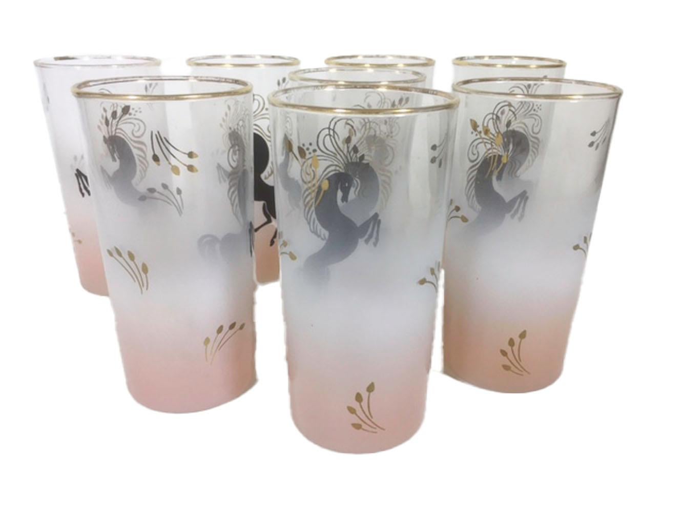 Set of eight Libbey highball glasses. Clear glass frosted pink at the base, fading to cleat at the top, decorated with a stylized rearing horse in black enamel with flowing mane and tail in 22k gold.