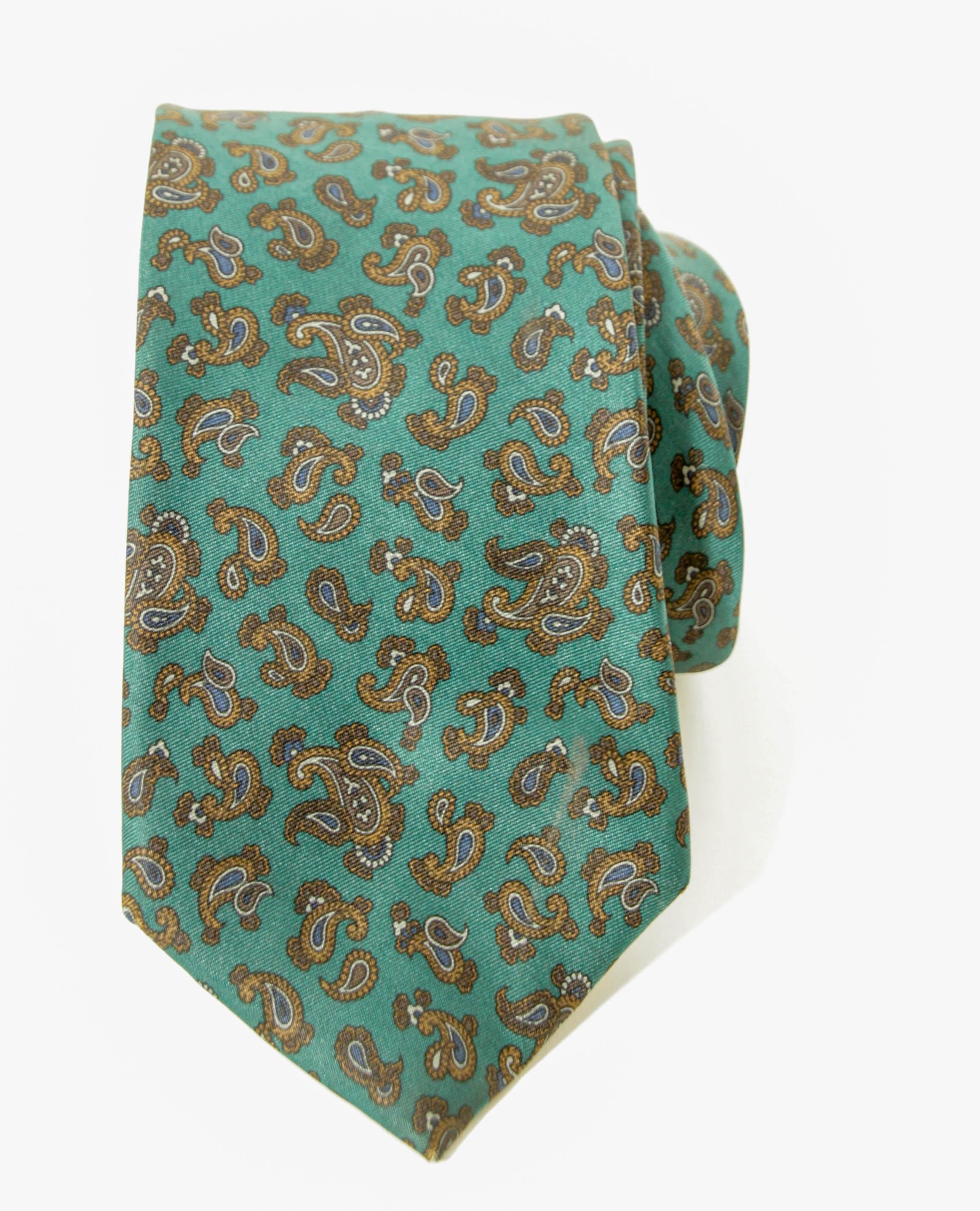 Vintage LIBERTY of London silk tie men dress necktie.
LIBERTY of London Silk Tie With Paisley Motifs in green and brown printed silk, handmade in England.
Dress luxury silk necktie designed by LIBERTY London. 
Made in England.
100% silk Dry clean