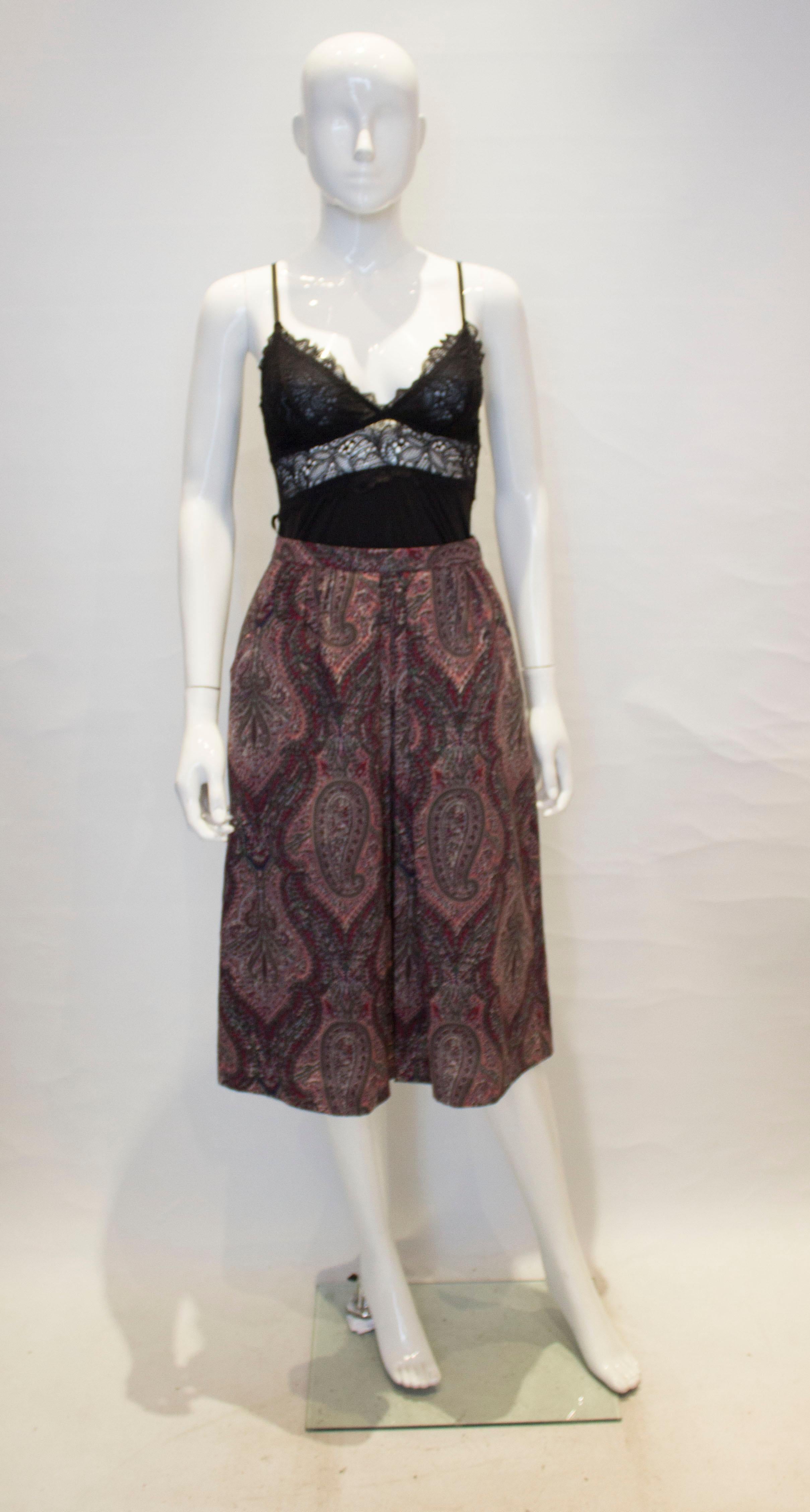 A great vintage skirt for Fall, from Liberty of London. The skirt is in a paisly print of plum, grey and pink. It has a pocket on either side, side zip opening and is fully lined.