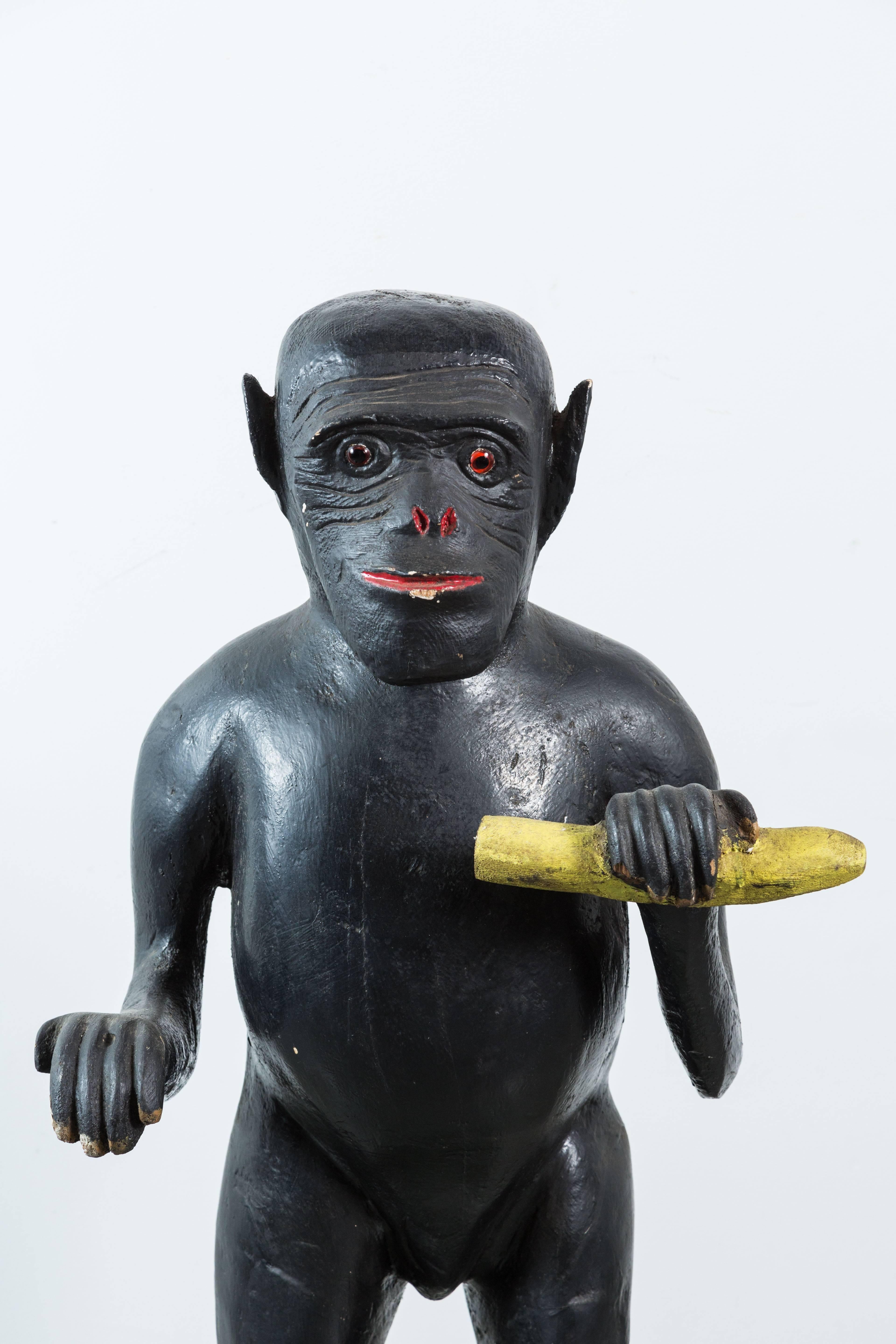 Vintage wood carved monkey with banana. Pretty expressive with glass eyes and original paint surface. Perhaps a throw back from Norma Desmond and Sunset Boulevard? Life-sized carving.