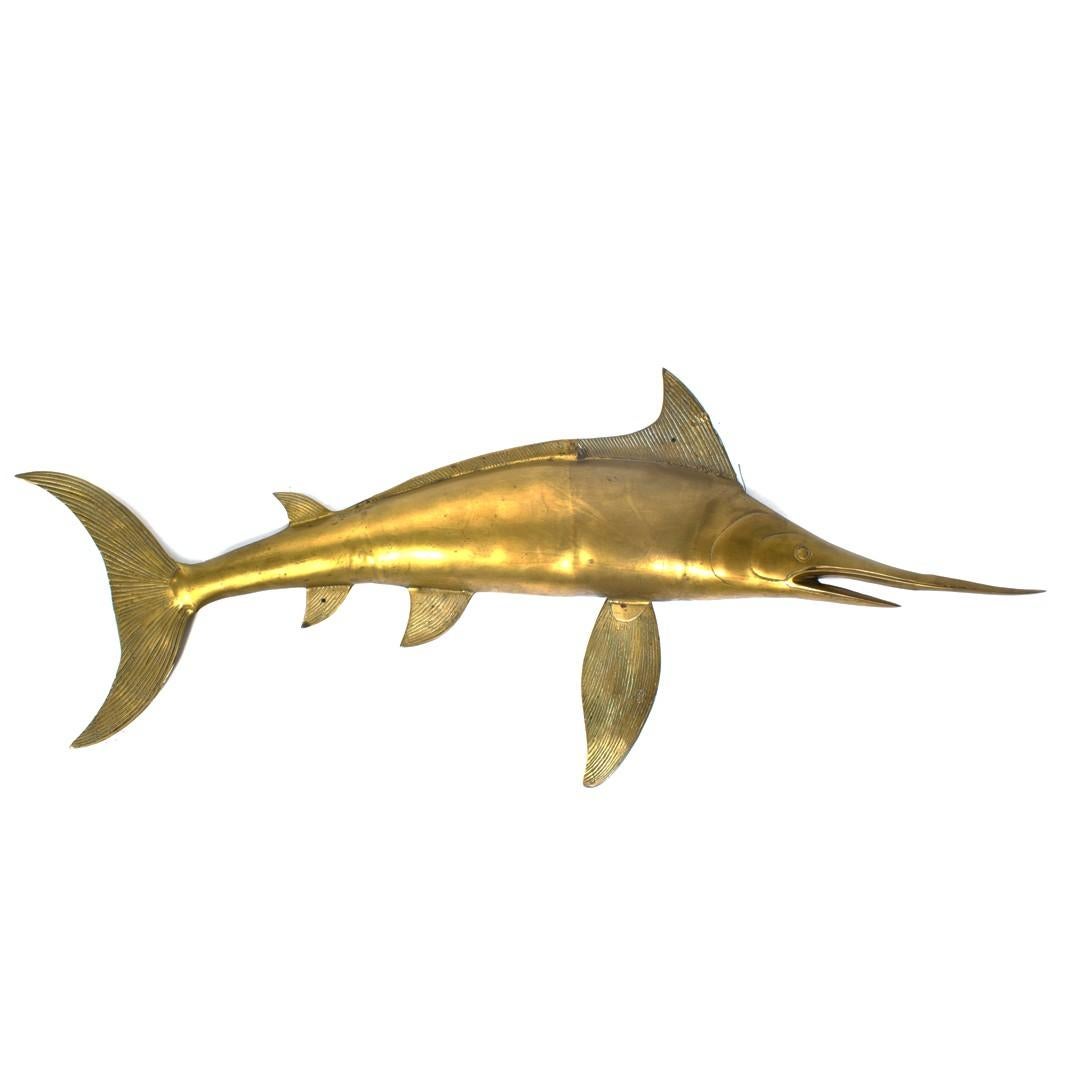 A lifesize vintage swordfish wall sculpture made of solid brass. Measuring a very large four feet long and 19 inches tall. USA, circa 1980.