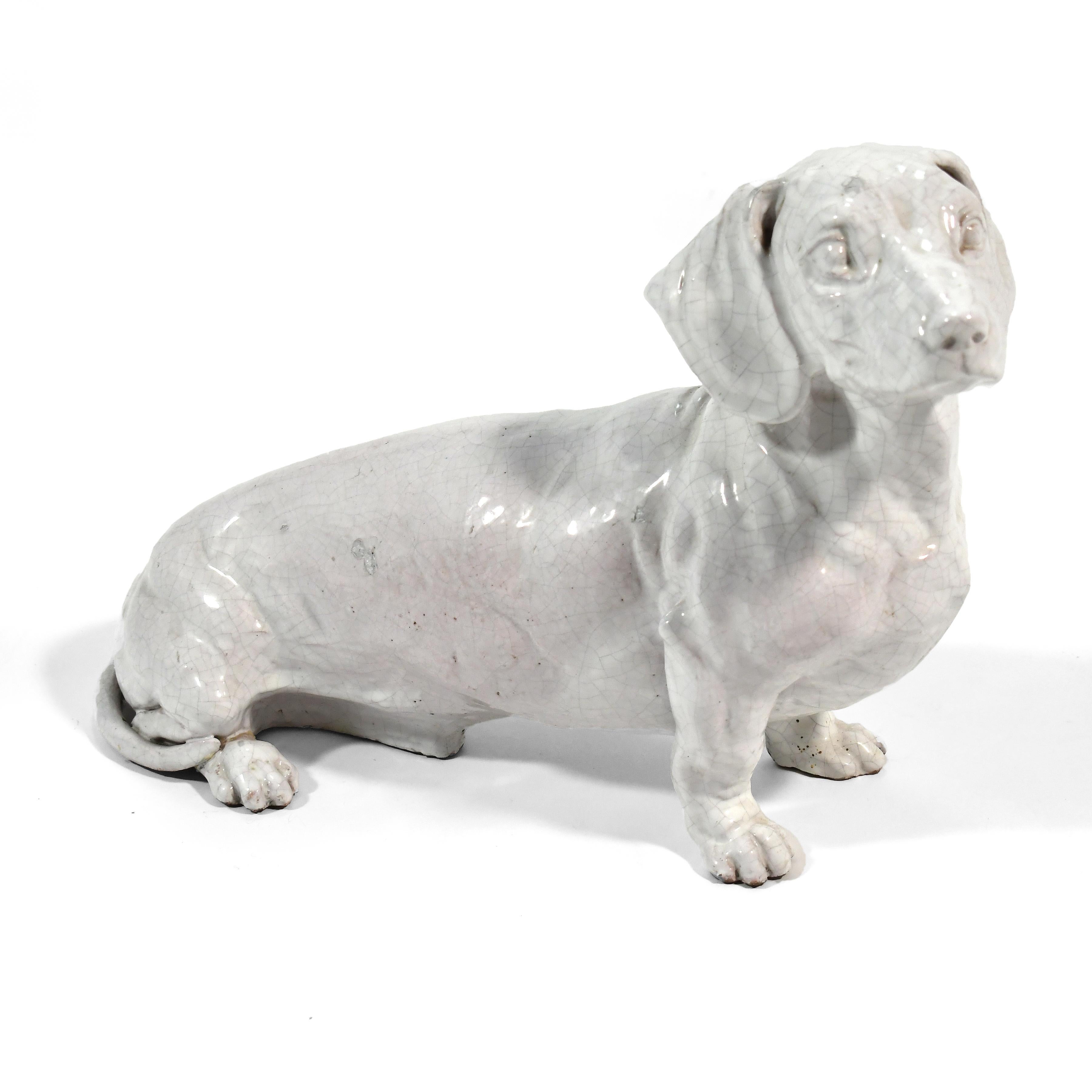 This charming Dachshund rendered in ceramic with a raku glaze has great presence with his stark white monochromatic finish. Very similar in style to a design by Ugo Zaccagnini

14
