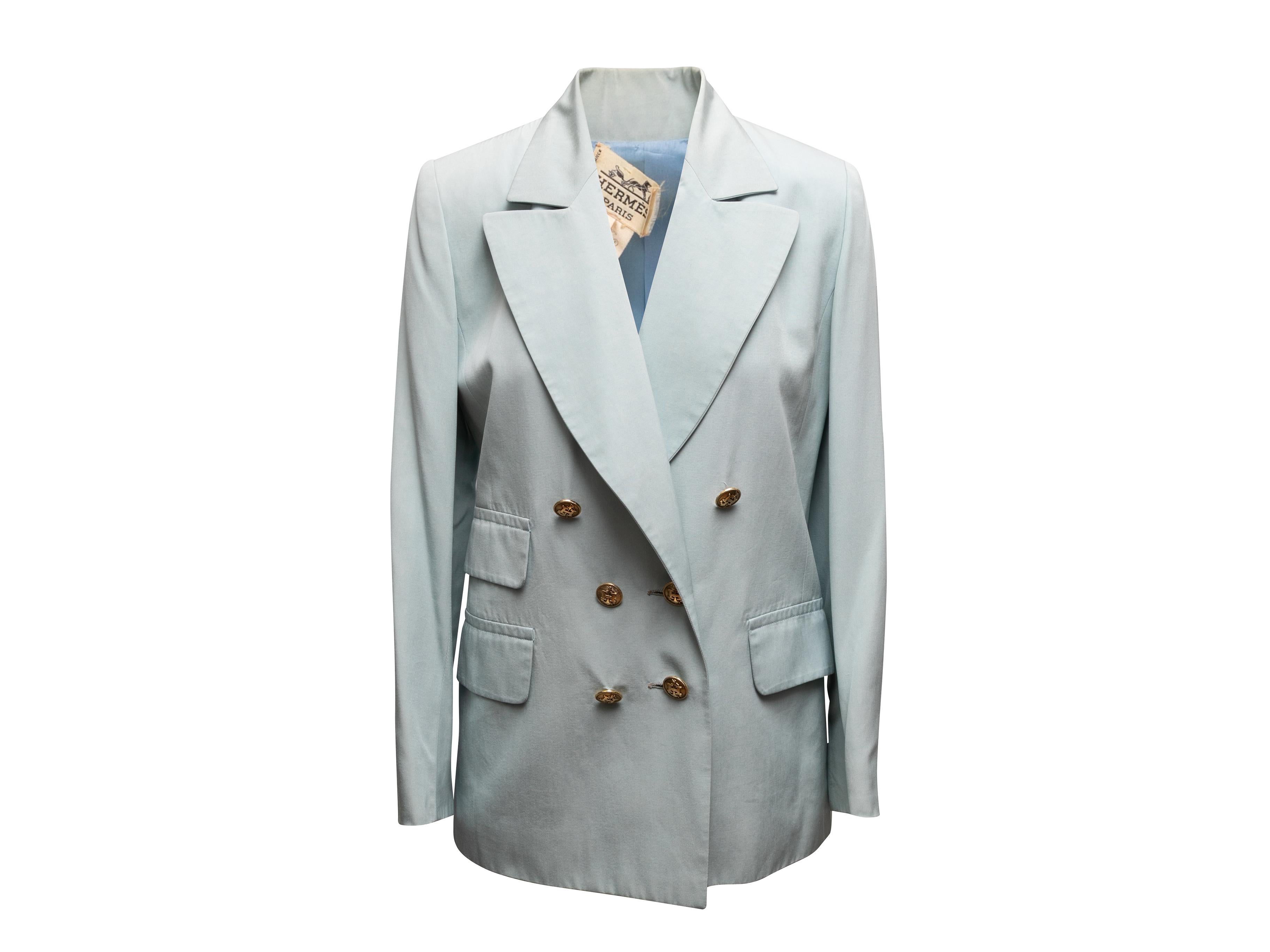  Vintage light blue double-breasted silk blazer by Hermes. Peaked lapels. Three pockets. Gold-tone button closures. 34
