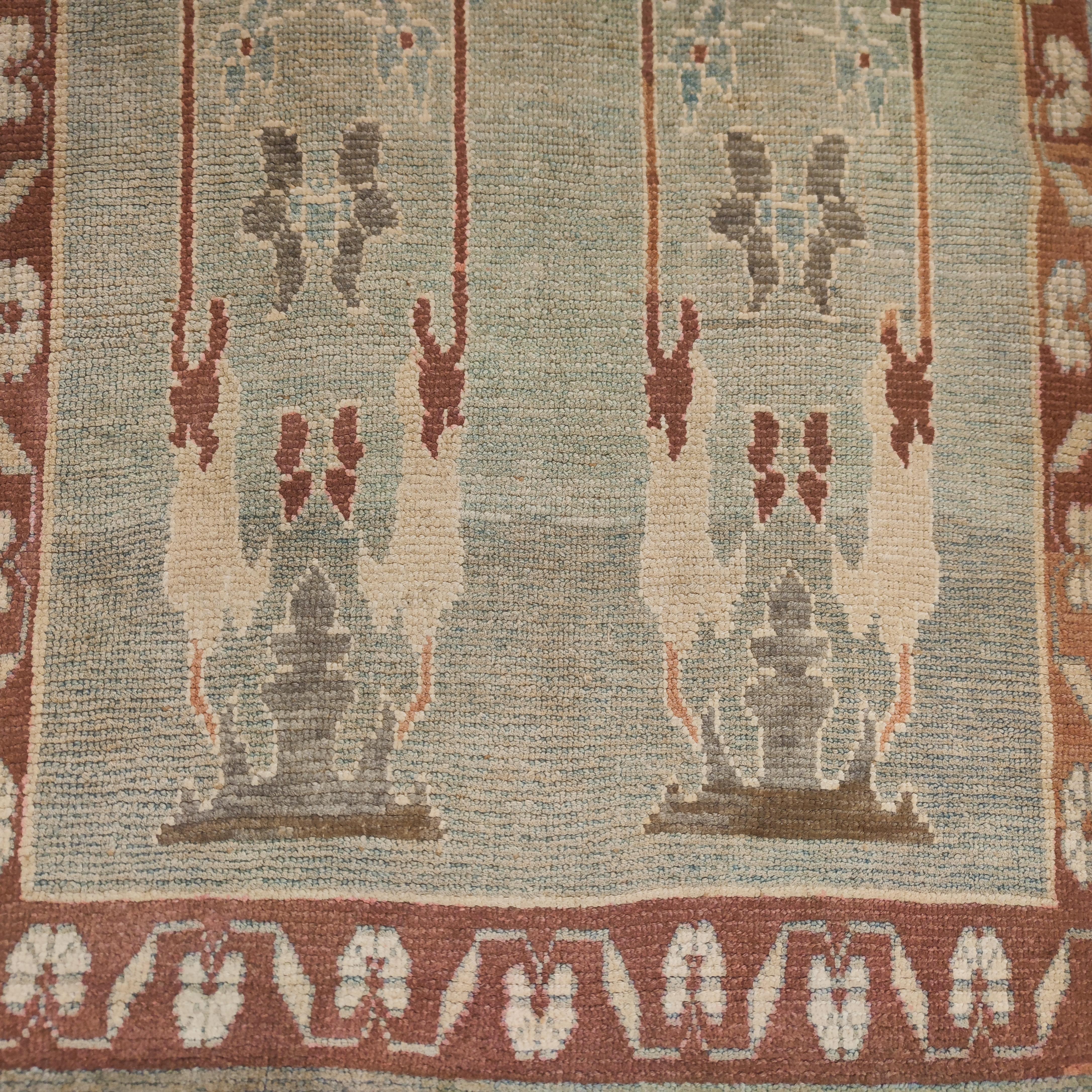 A highly refined Oushak rug distinguished by a stunning aqua blue background, embellished by an all-over pattern composed of large palmettes in light grey flanked by a network of elaborately drawn leafs in ivory and light brown. Designs of this type