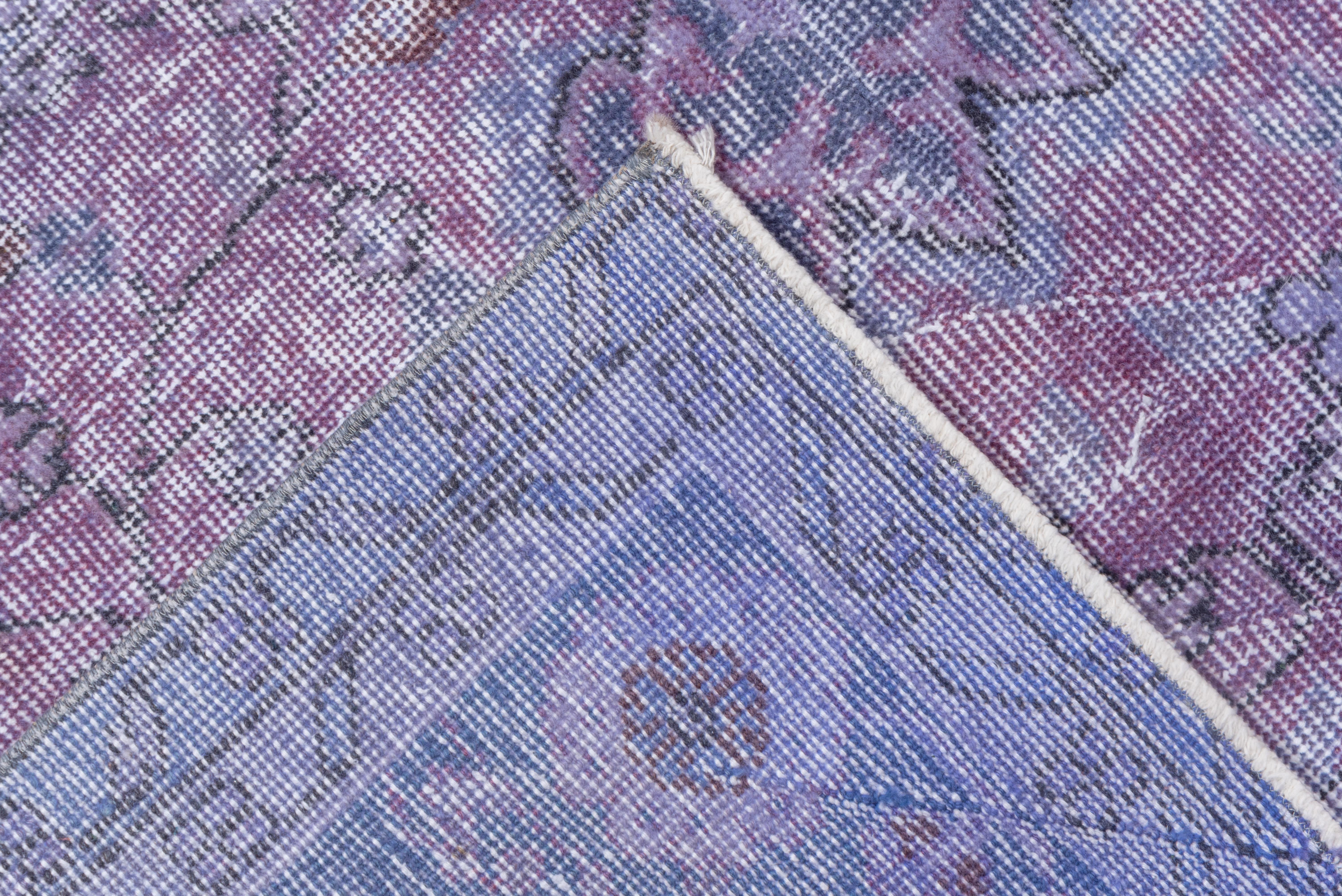 This light purple and pink Turkish overdye Sparta carpet has a pattern defined by the wear beyond the all-over general distress. Vertical and horizontal off white strips cross near the center. Shabby chic conditions and can offer some great texture
