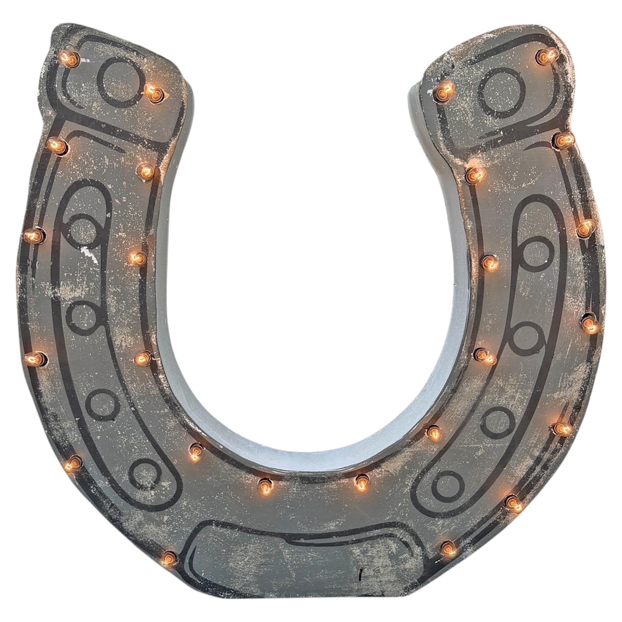 Enseigne vintage en forme de fer à cheval lumineuse