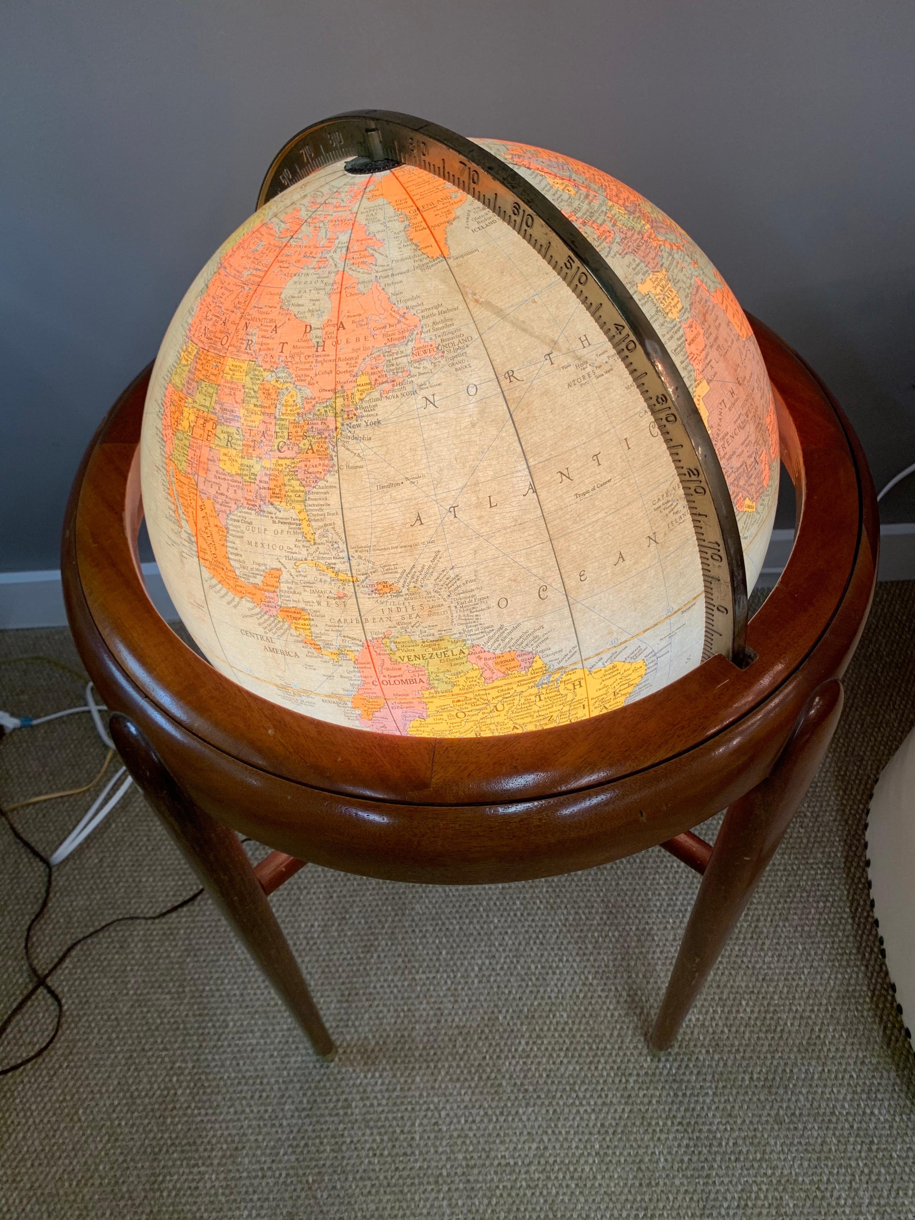 Rare to see a Mid-Century Modern globe both illuminated and with that iconic Danish modern look which is so coveted. Everything works as it should. Just gorgeous.