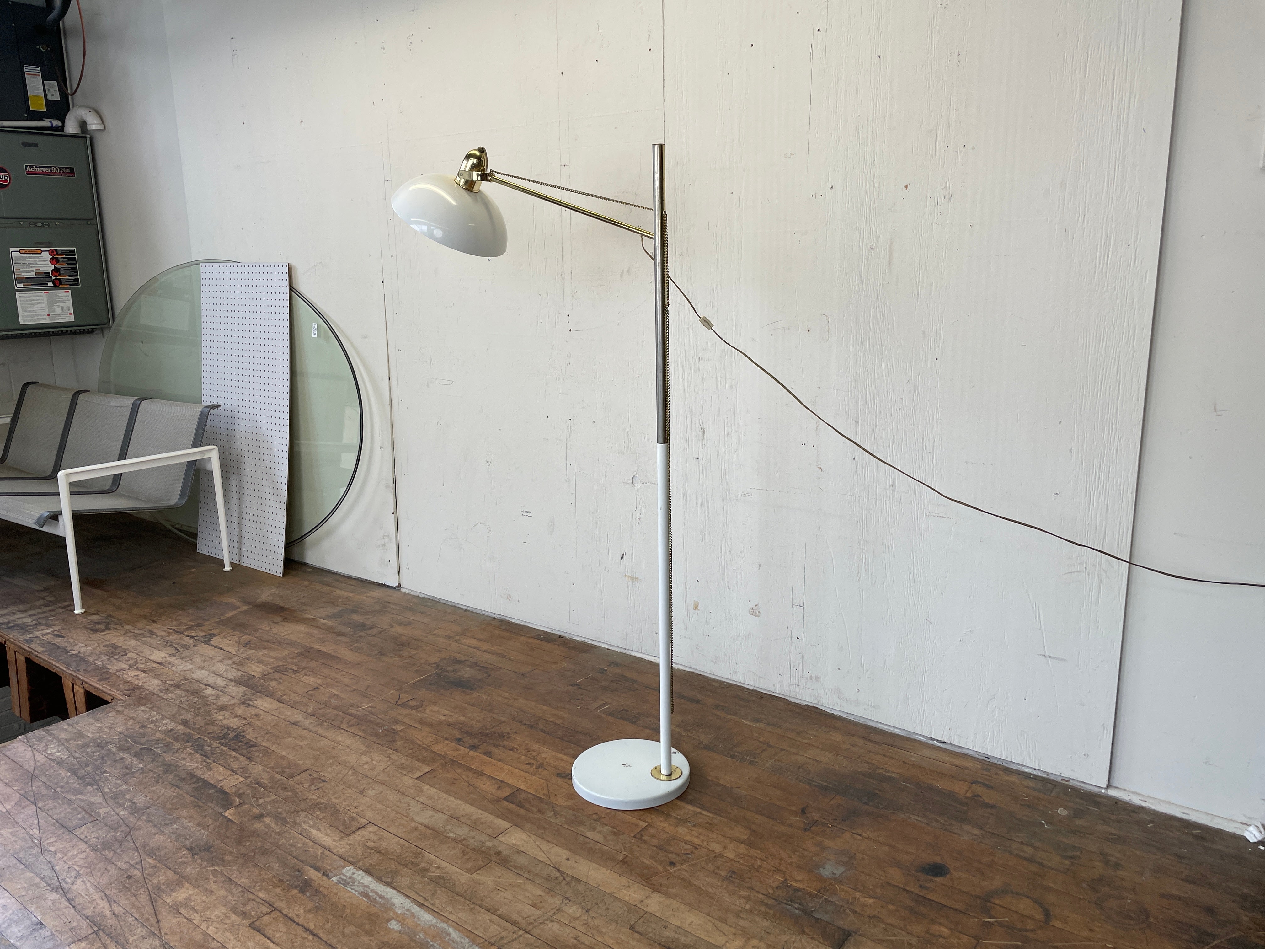 A stunning vintage floor lamp with an adjustable cantilevered design and enameled metal frame. A brass chain connects to the shade and allows the lamp head to be raised or lowered. Good vintage condition with no significant damage. Wiring is sound.