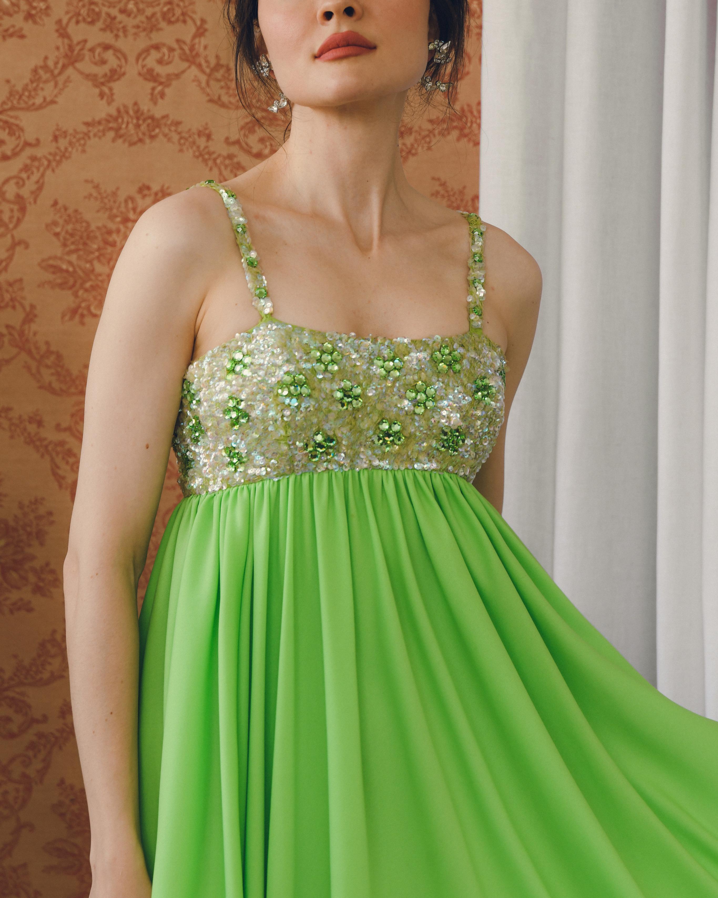 This vintage Lillie Rubin gown features an empire-waist bodice fully blanketed in sequins and embellishment. At the empire waist, the jersey fabric is gathered and falls in a column shape. It comes with a matching shawl that can be draped and worn a