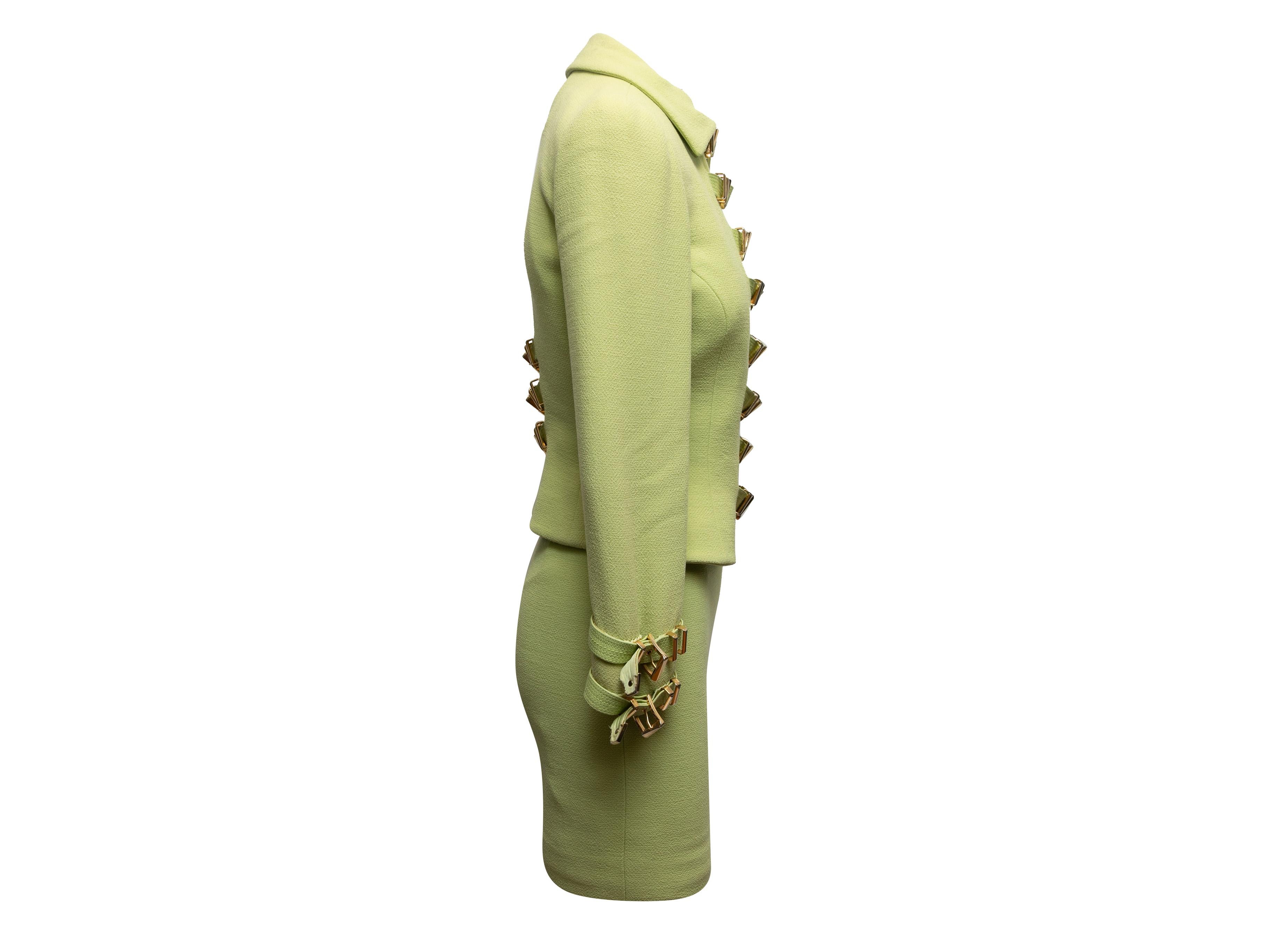 Vintage lime green skirt suit by Gianni Versace Couture. From the Fall/Winter 1992 Collection. Blazer features pointed collar and multi-buckle front closures. Skirt features fitted waist. Blazer- 25