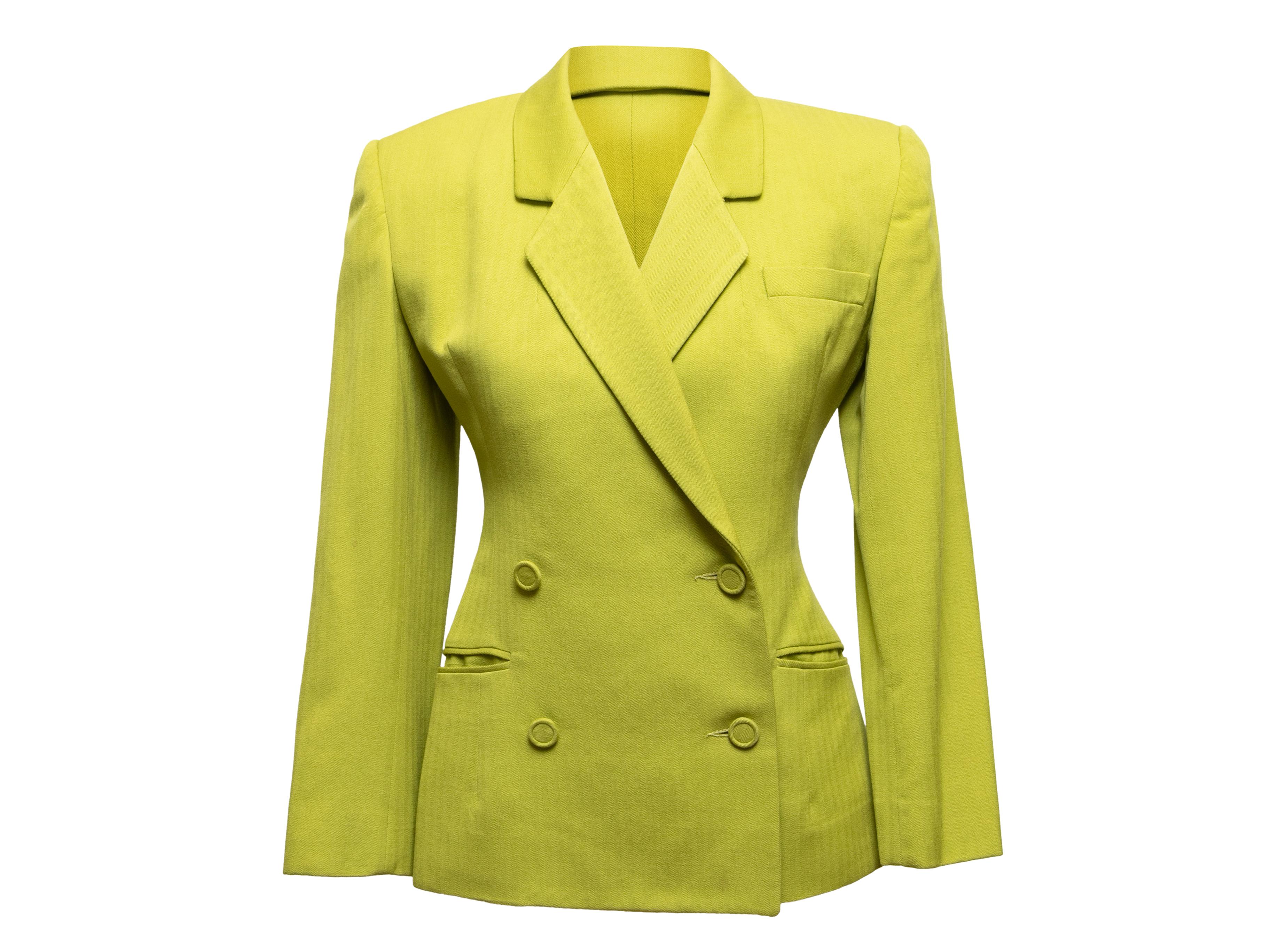 Vintage lime green double-breasted blazer by Omo Norma Kamali. Circa 1980s. Notched lapel. Structured shoulders. Three welt pockets. Front button closures. 34