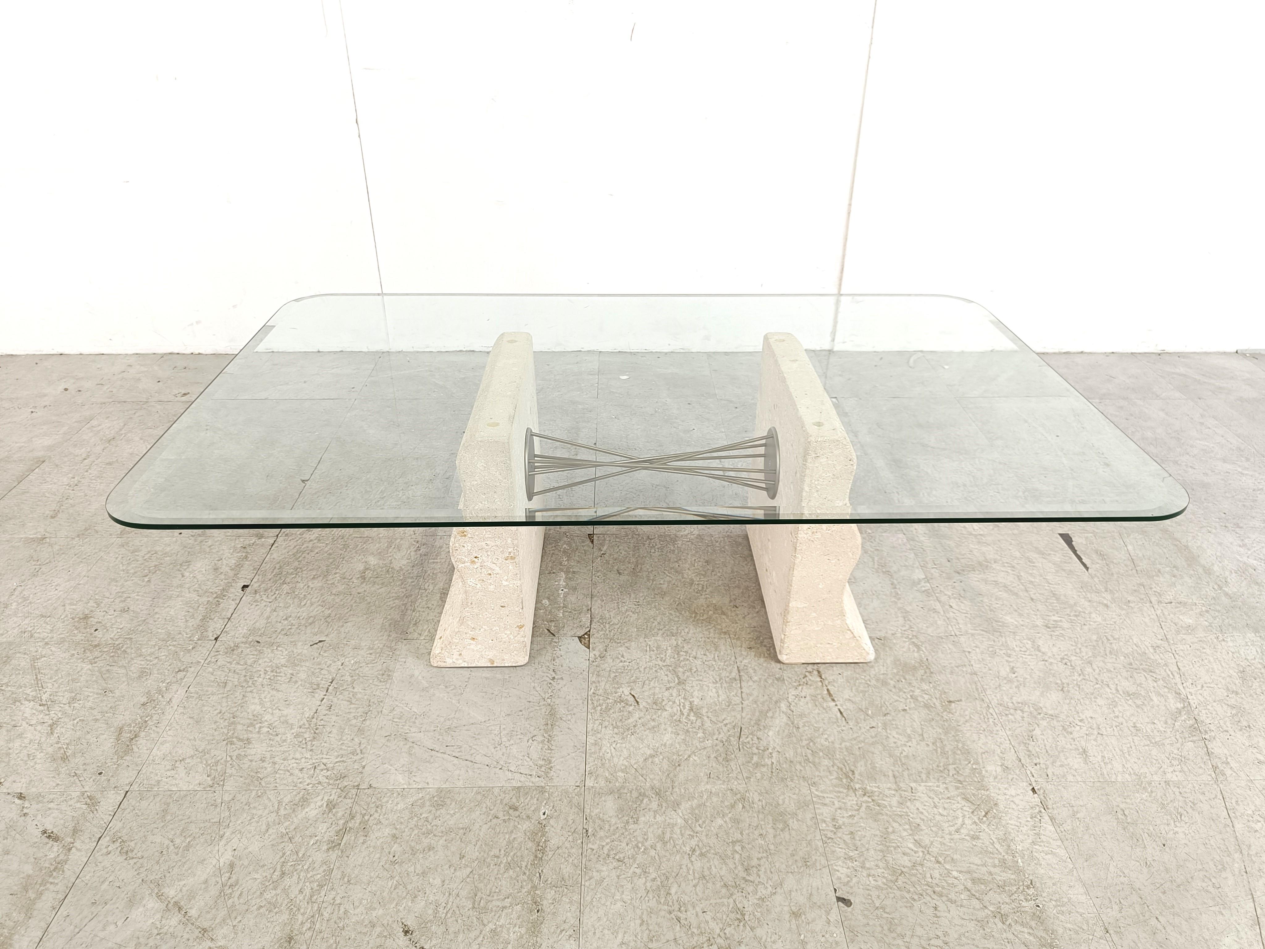 Elegant coffee table with two curved lime stone bases connected with a twisted metal wire piece and a clear glass beveled table top.

Beautiful timeless piece.

Very good condition

1990s - Italy

Dimensions
Height: 40m/15.74