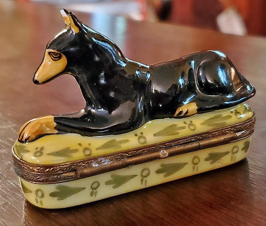 Presenting a gorgeous vintage Limoges Doberman Pinscher ring box.

20th century …. circa 1960-1980. Fully marked on the base for “Limoges France … Cpeint Main (Hand-painted) …. M.J.”

Also marked on the interior.

Made of porcelain/ceramic and