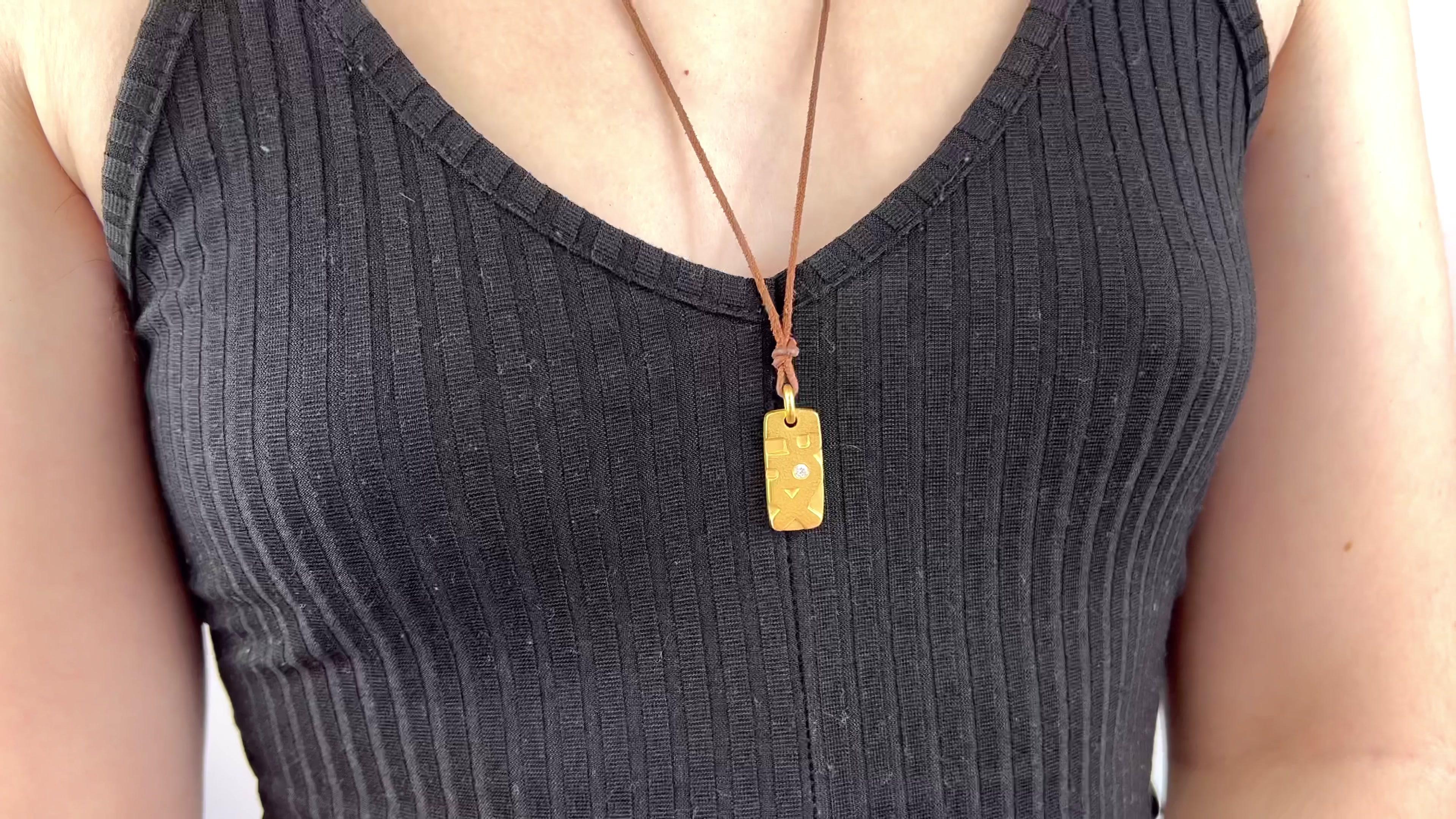 One Vintage Linda Lee Johnson Diamond 21 Karat Gold Cord Pax Necklace. Featuring one round brilliant cut diamond of approximately 0.08 carat, graded E color, VVS clarity. Crafted in 21 karat yellow gold, with Linda Lee Johnson maker's mark. Circa