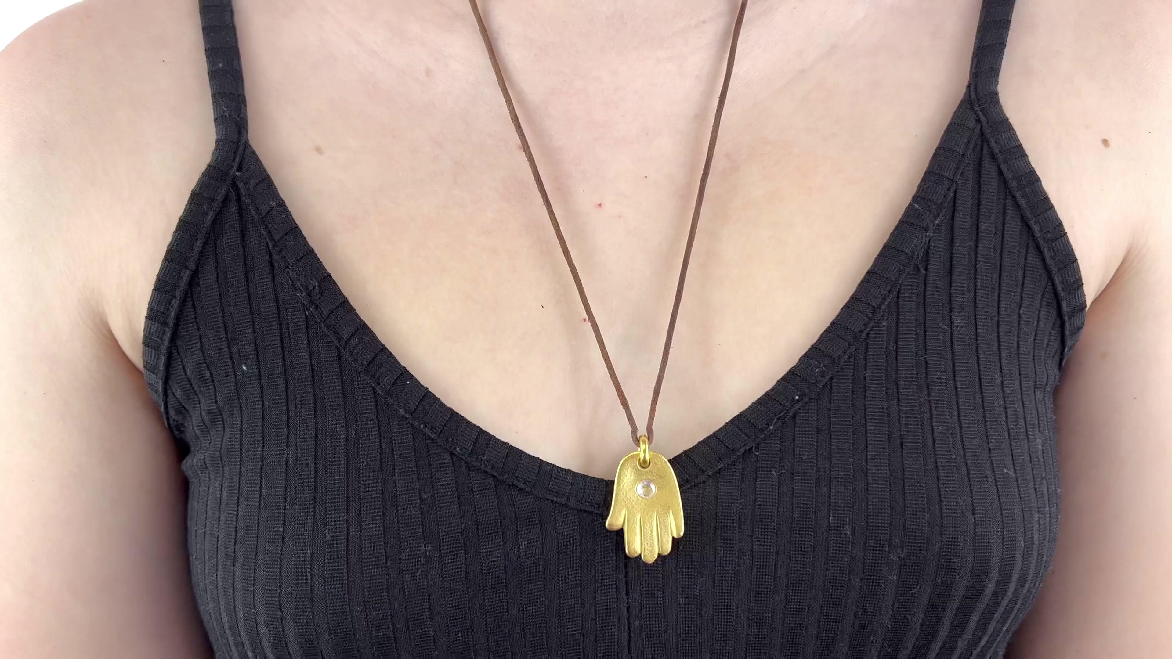 One Vintage Linda Lee Johnson Diamond 21 Karat Gold Leather Cord Hand Necklace. Featuring one rose cut diamond weighing approximately 0.20 carat, graded E VVS. Crafted in 21 karat yellow gold, with Linda Lee Johnson maker's mark. Circa 1990s. The