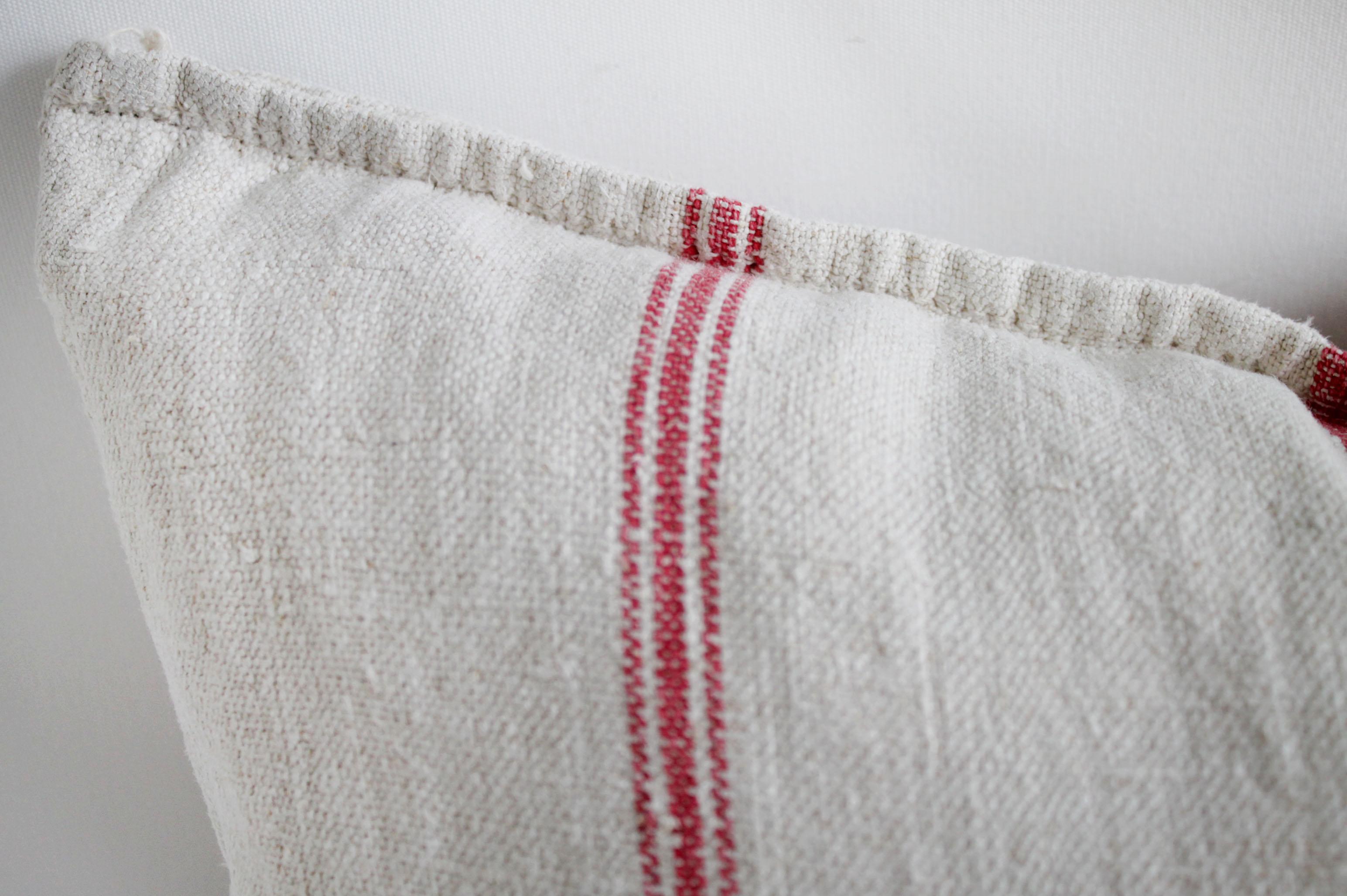 This pillow is a vintage French linen grain sack, with true red colored stripes. Front and back are the same material. Our pillows are constructed with vintage one of a kind textiles from around the globe. Carefully constructed with the finest