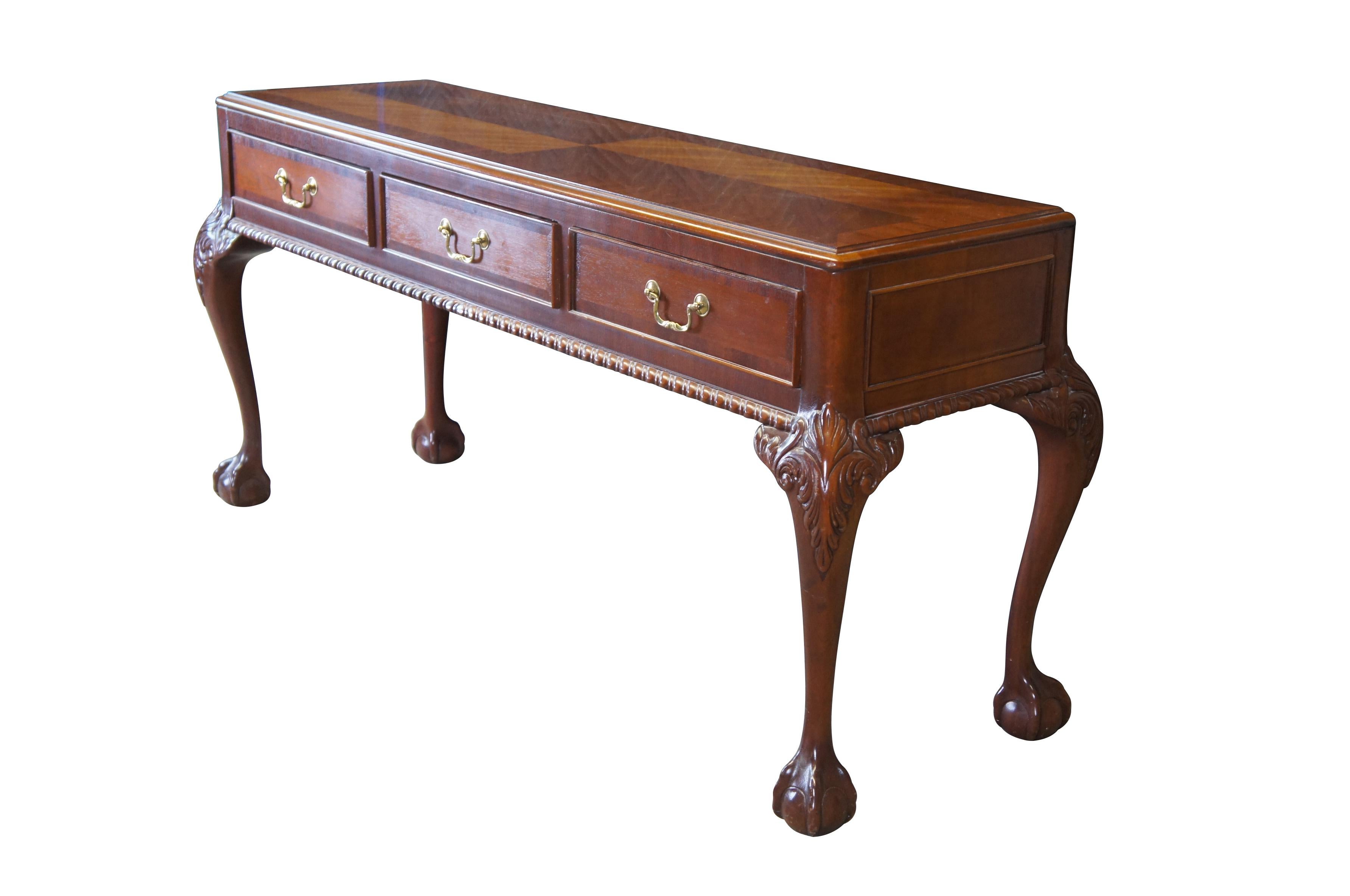 Mid 20th Century console or sofa table by Link Taylor.  Made from Solid Mahogany in Lexington, North Carolina.  Features a mahogany frame with matchbook top, features three dovetailed drawers within the frieze, brass bale hardware, gadrooning along