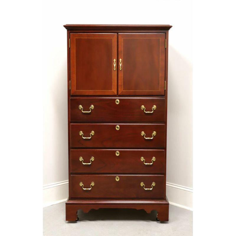 A tall chest in the Chippendale style by Link-Taylor. Mahogany with brass hardware and bracket feet. Features upper cabinet above four drawers of dovetail construction with faux lock plates. Upper cabinet has built-in electrics and can accommodate