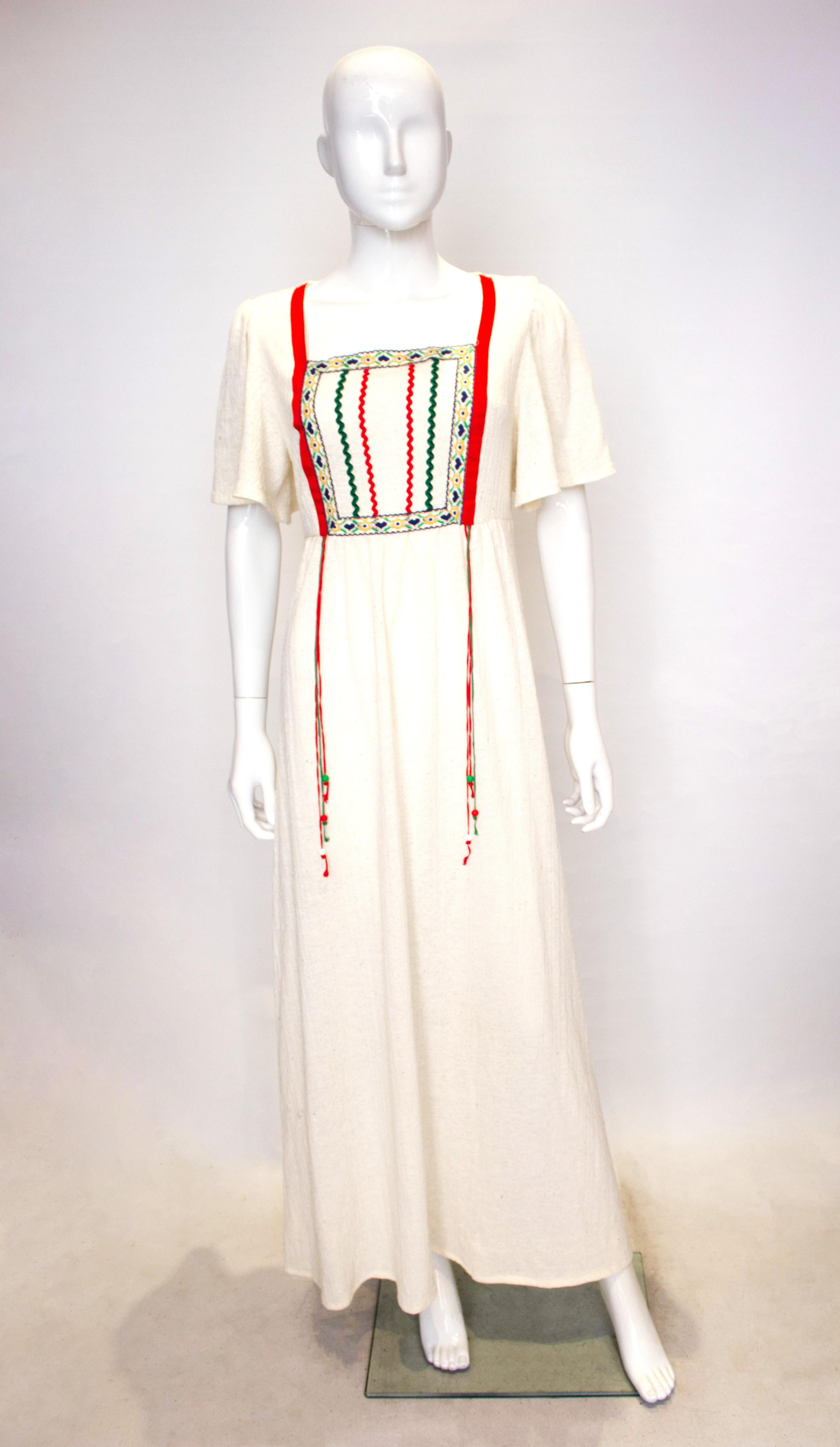 A lovely vintage dress from Linzi that is great for wafting around in. The cheesecloth dress has a square neckline , red ribbon detail and lace on the front. 