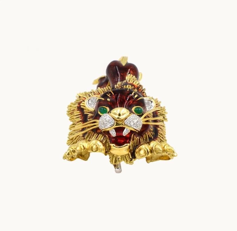 A vintage lion brooch in 18 karat yellow gold from circa 1980s.  This awesome, large lion features enamel detailing along with emerald eyes and and diamond nose and ears.  The approximate total diamond weight is 0.80 carats.

This brooch measures