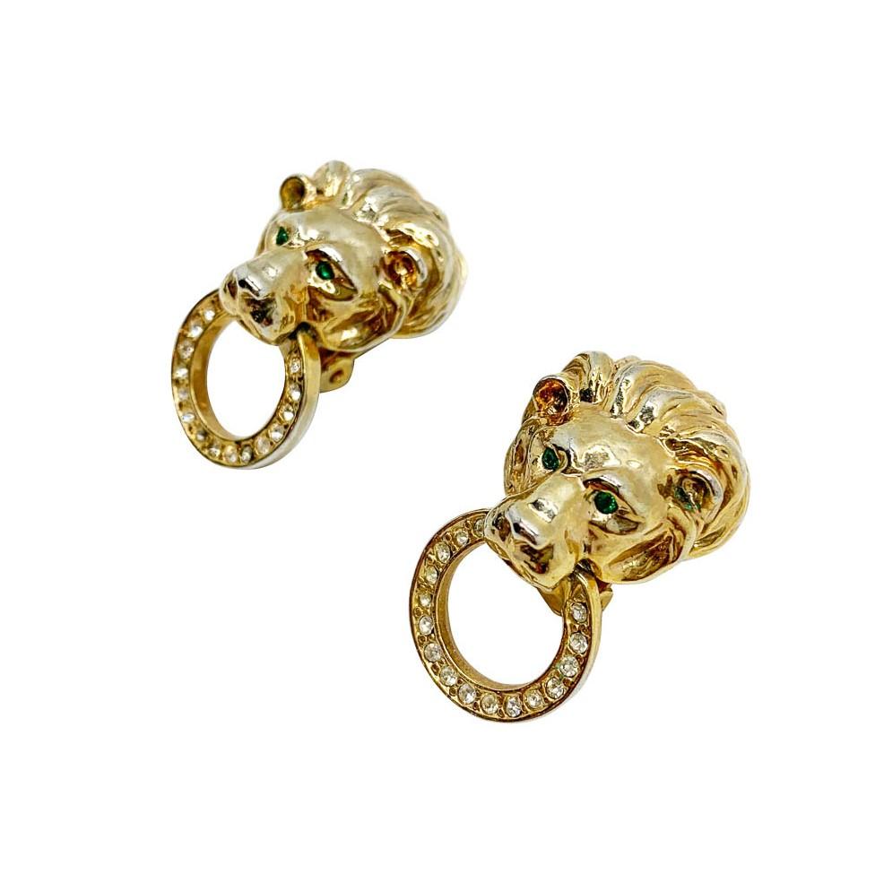 A pair of vintage lion hoop earrings. Featuring a door knocker design incorporating a lions head and ring set with crystals.

Vintage Condition: Good vintage condition with very very slight plate wear, unnoticeable when worn.
Materials: gold plated