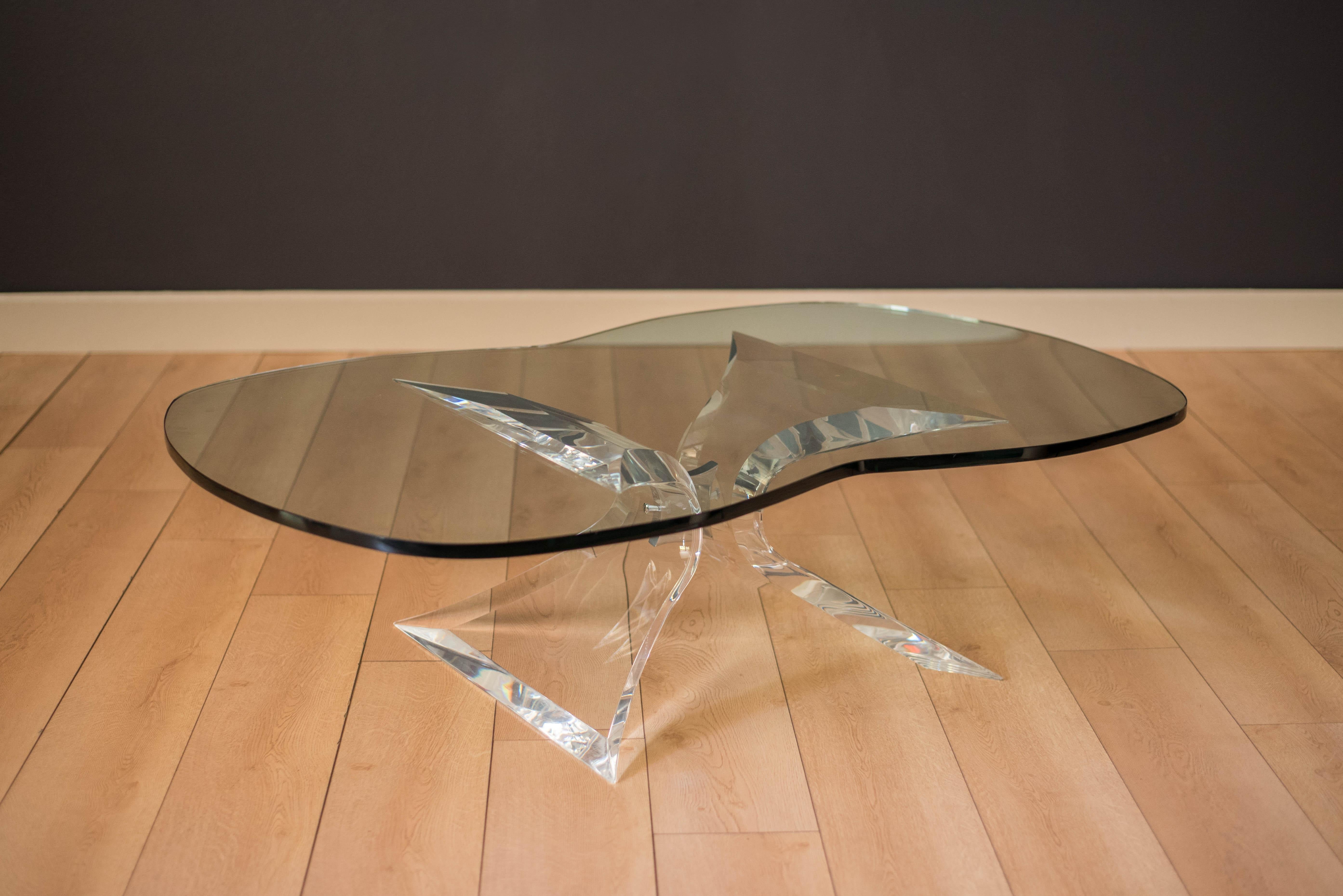 Mid-Century Modern Lucite and glass coffee table signed 'Lion in Frost'. This piece features a sculptural acrylic butterfly base with polished chrome accents. Unique wing shaped glass top adds more transparency designed to create depth for any